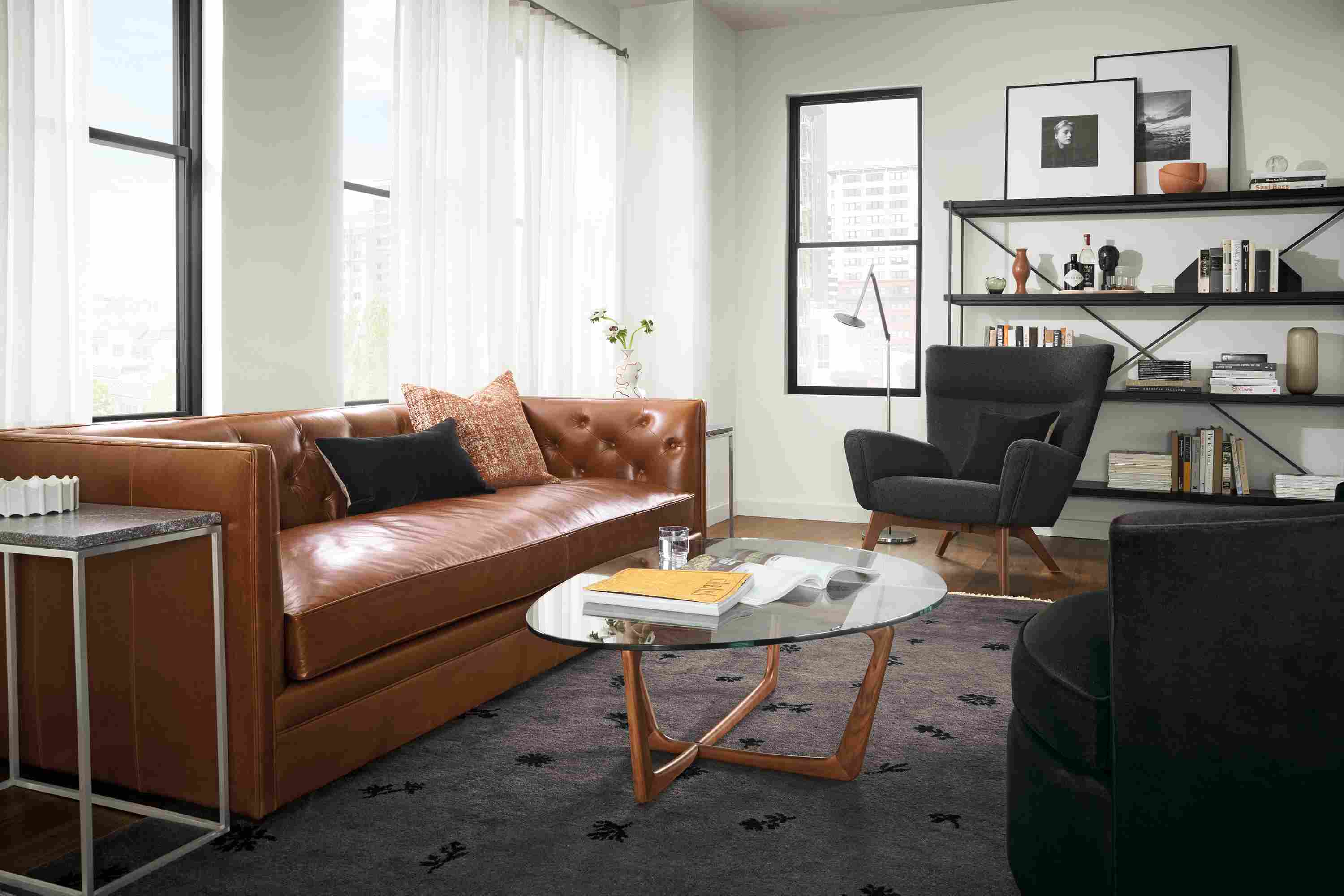 Living room with Macalester leather sofa in Vento Cognac and Dunn coffee table in cherry with clear glass top.