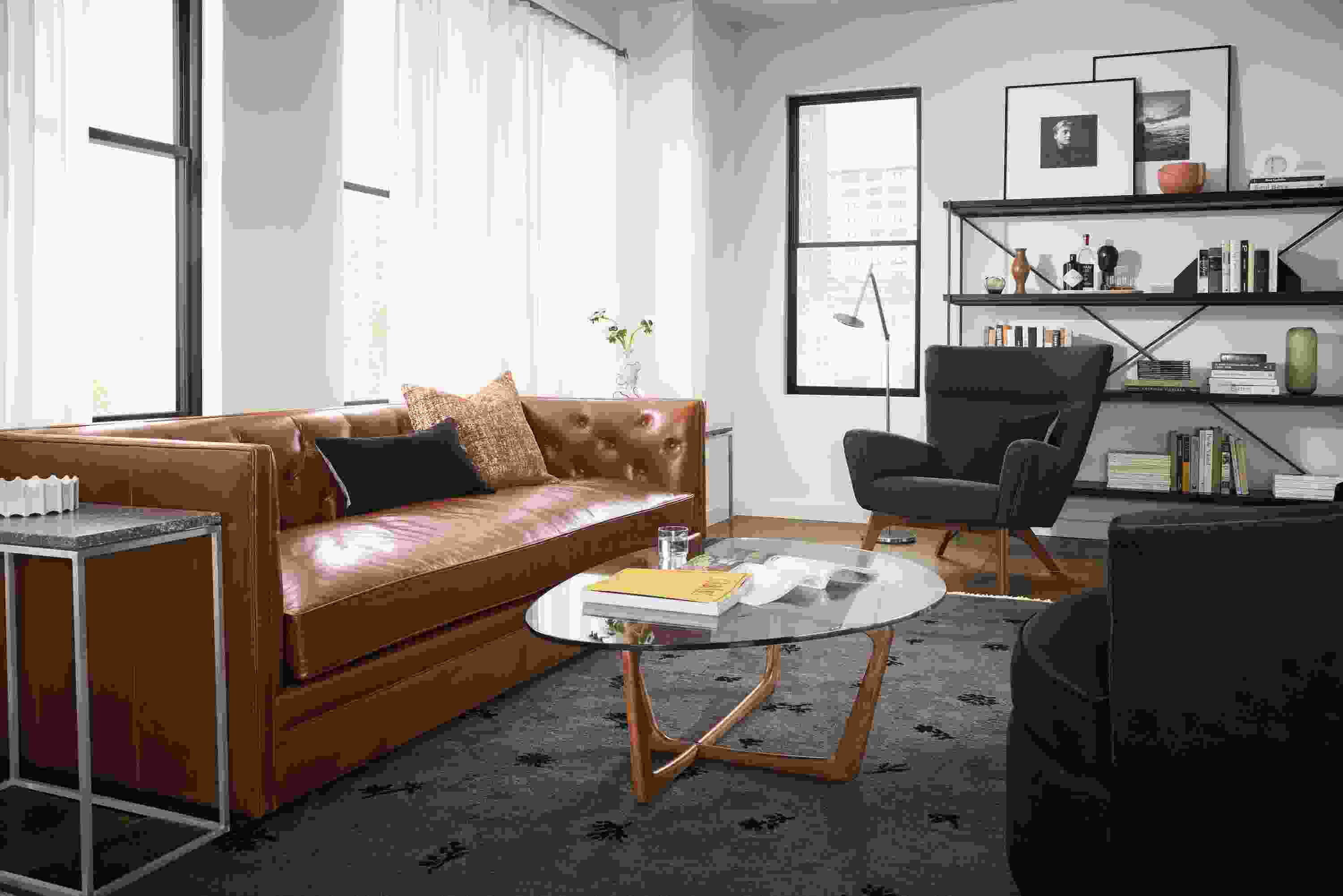 Living room with Macalester leather sofa in Vento Cognac and Dunn coffee table in cherry with clear glass top.
