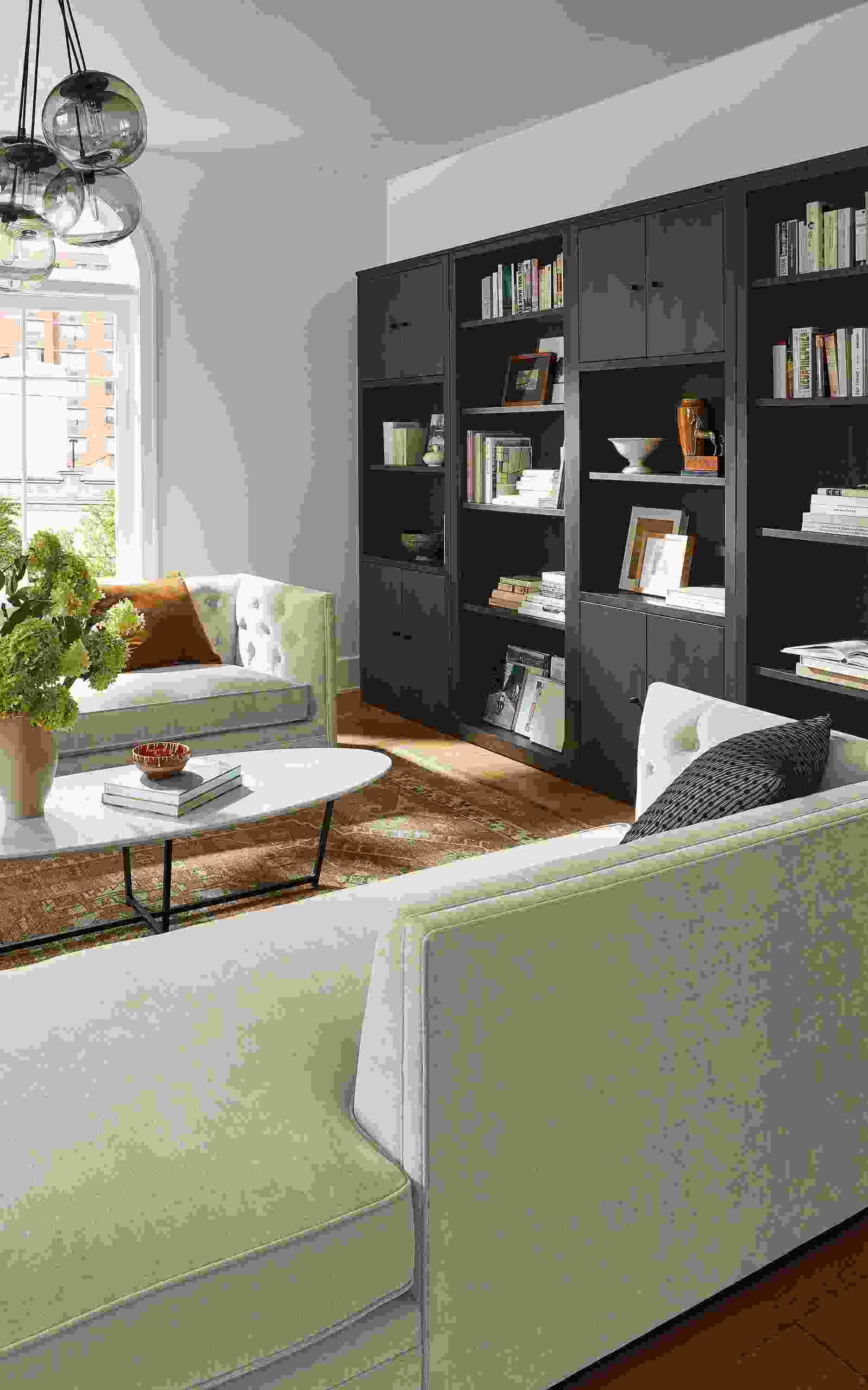Living room with Macalester chaise and sofa in Mori oatmeal, Woodwind bookcases in charcoal.