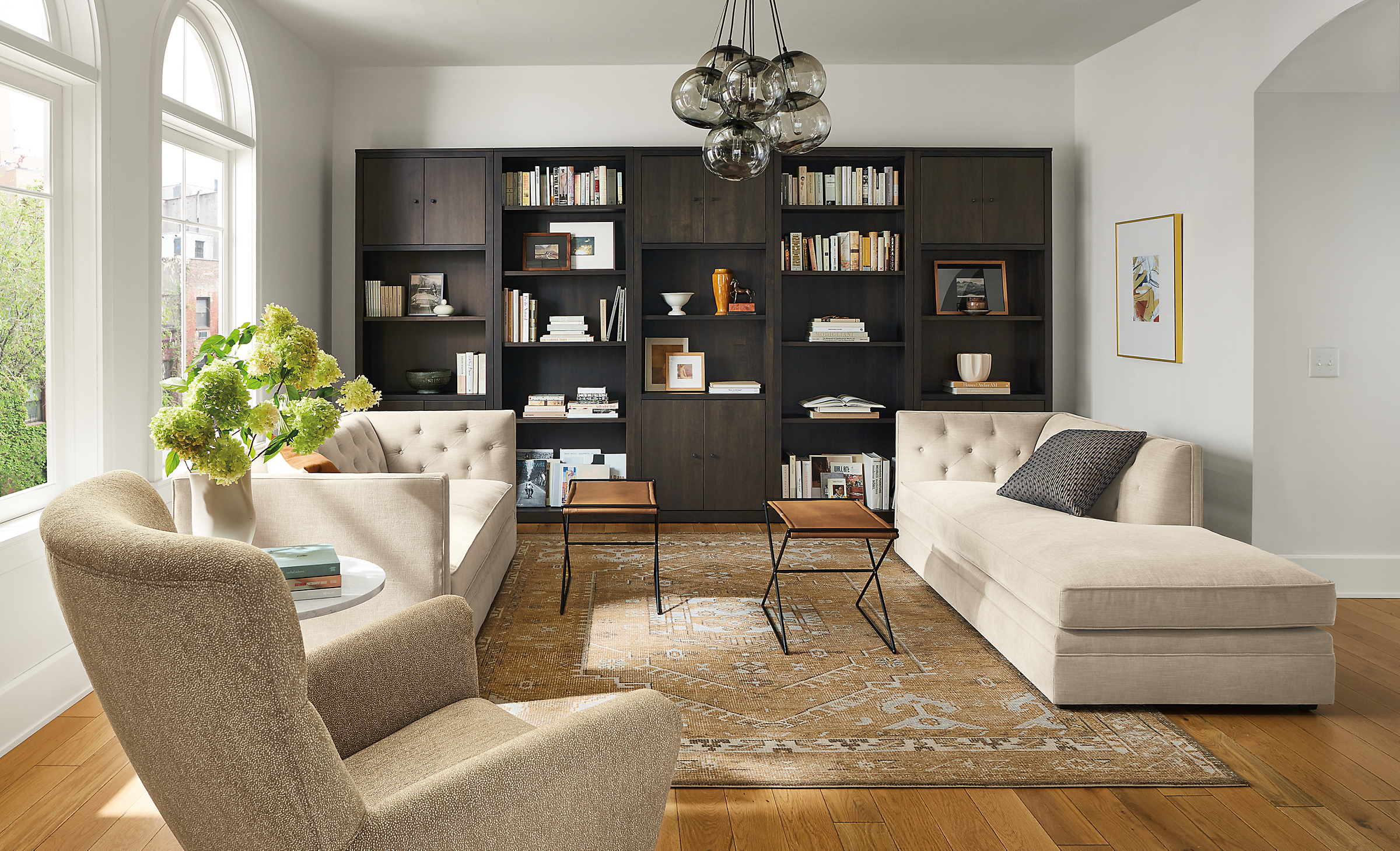living room with macalester sofa and macalester chaise, charcoal woodwind bookcases, darrah rug.