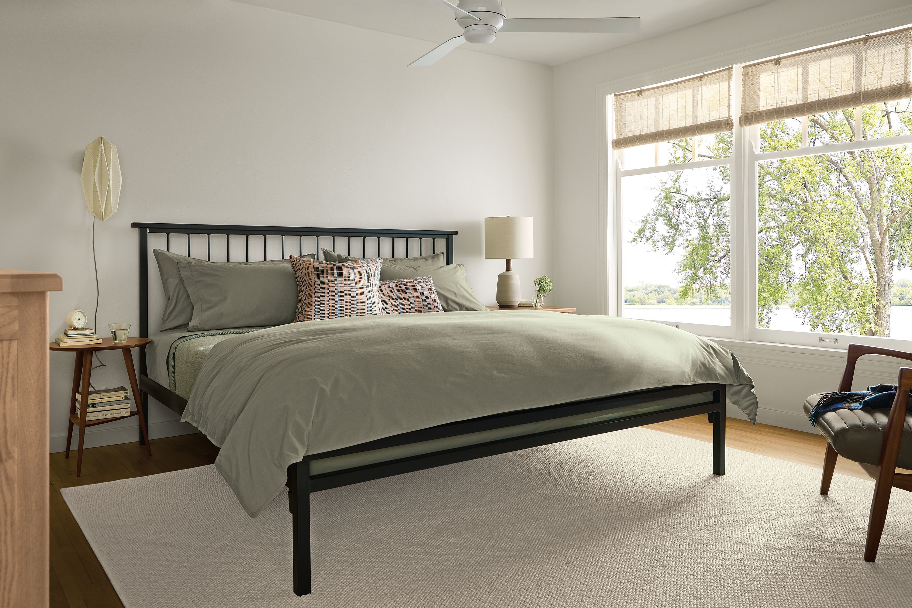 Bedroom with Mackintosh king bed in natural steel with soft washed percale duvet and sheet set in moss.