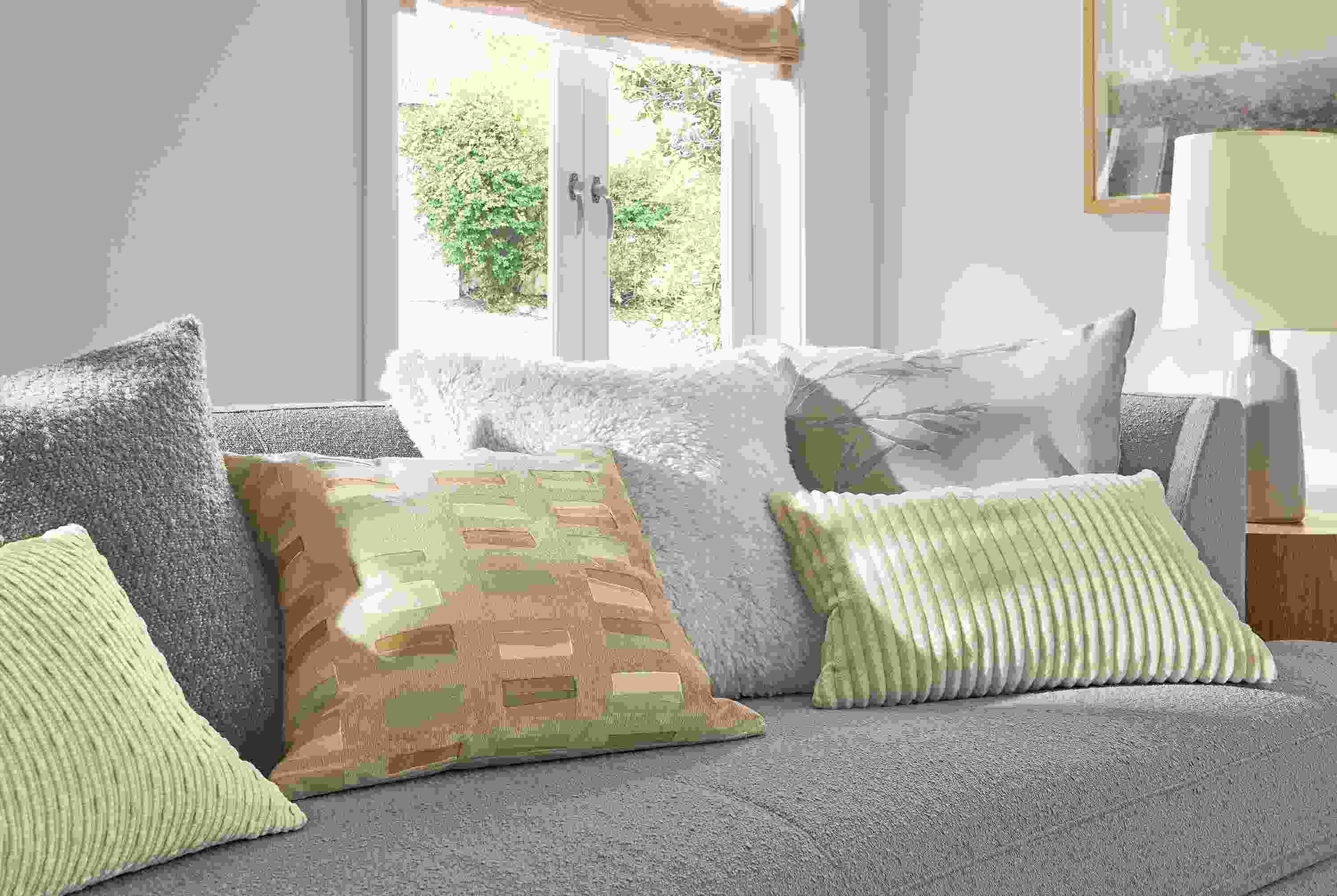 Living room with a group of pillows including Macy, Palmer, Capa, Fairmont and Gavin and Liana on an Astaire sofa.