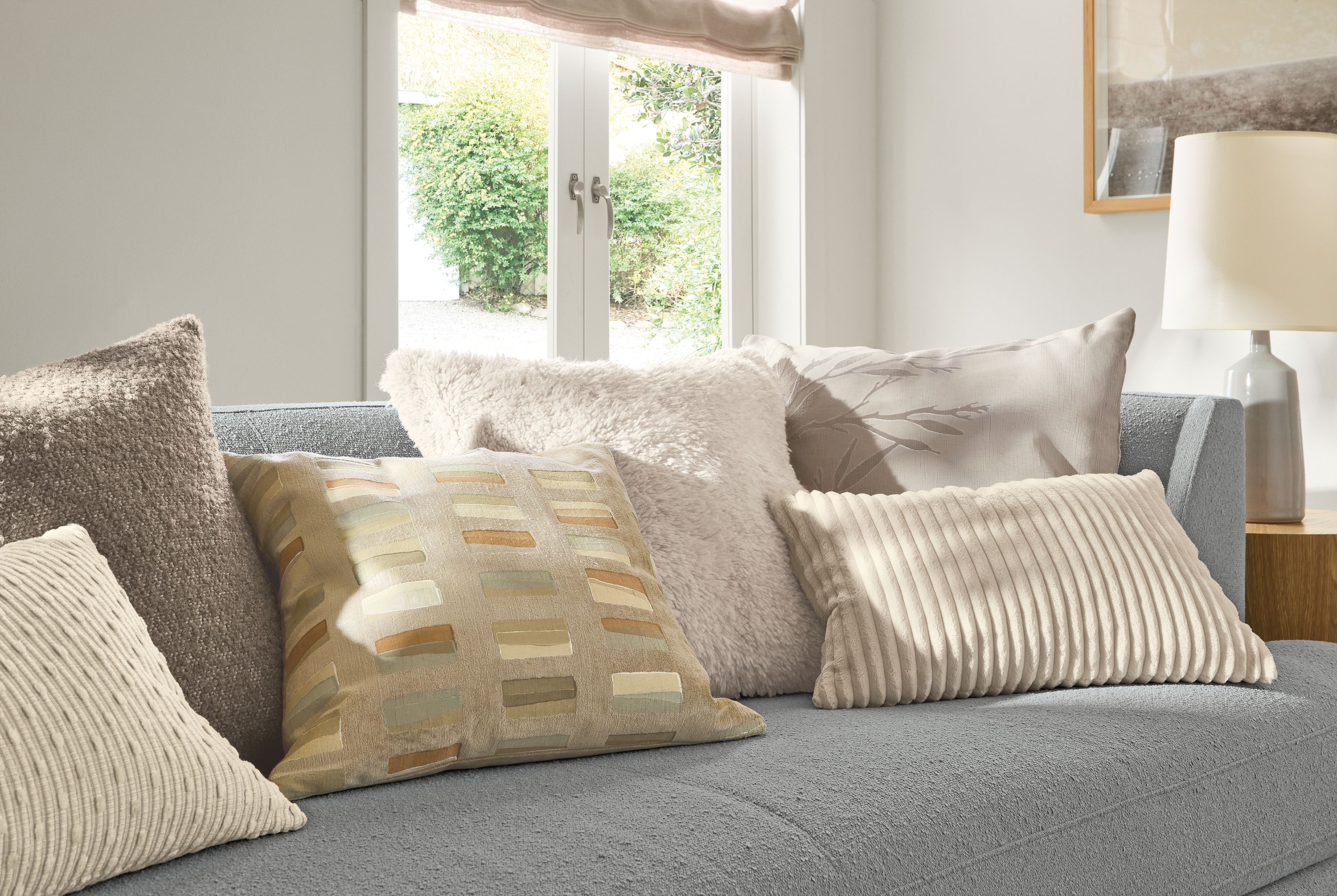 Living room with a group of pillows including Macy, Palmer, Capa, Fairmont and Gavin and Liana on an Astaire sofa.