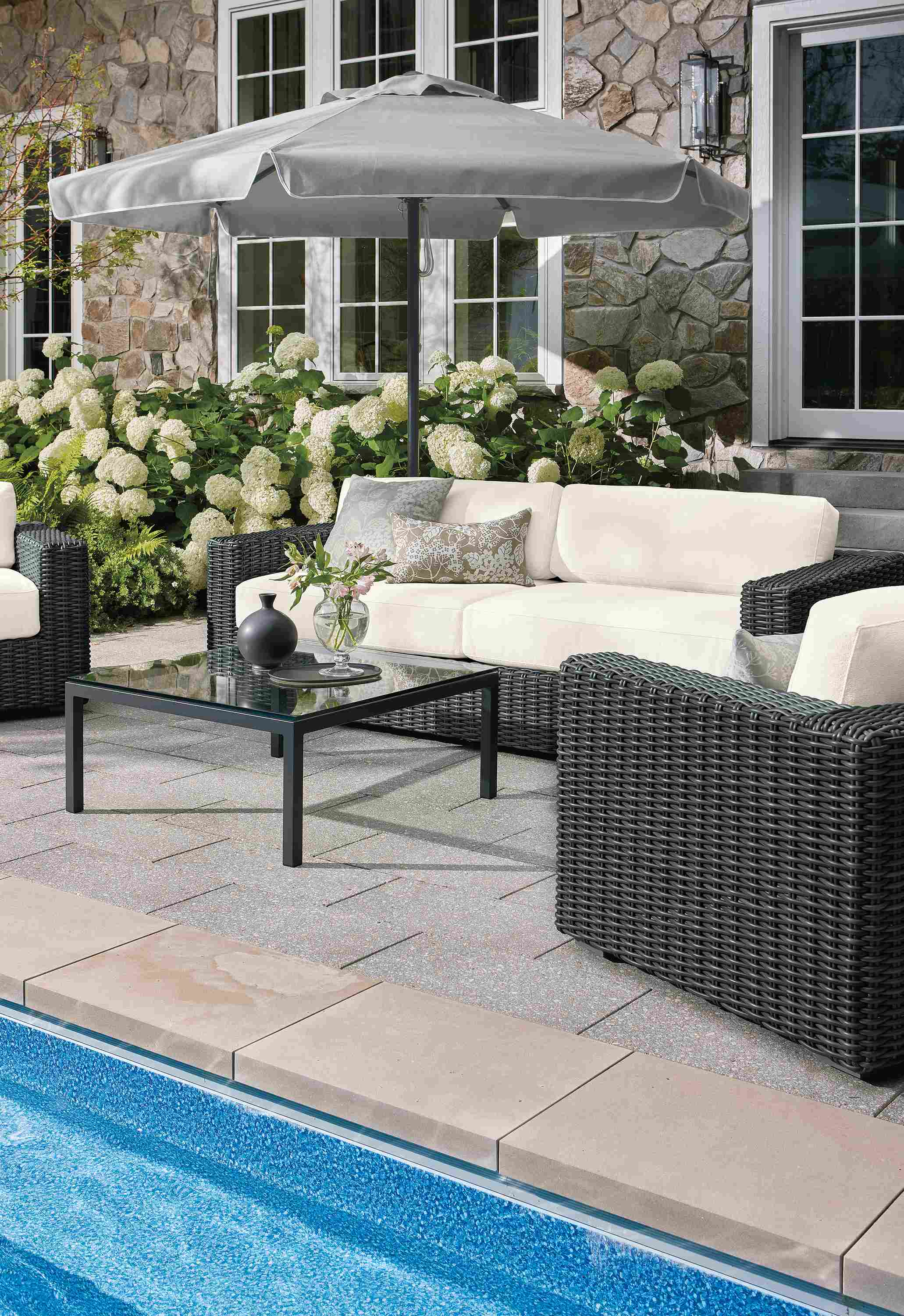 Poolside patio with 2 Madura lounge chairs and 95-wide sofa in Dusk Ivory and charcoal weave.