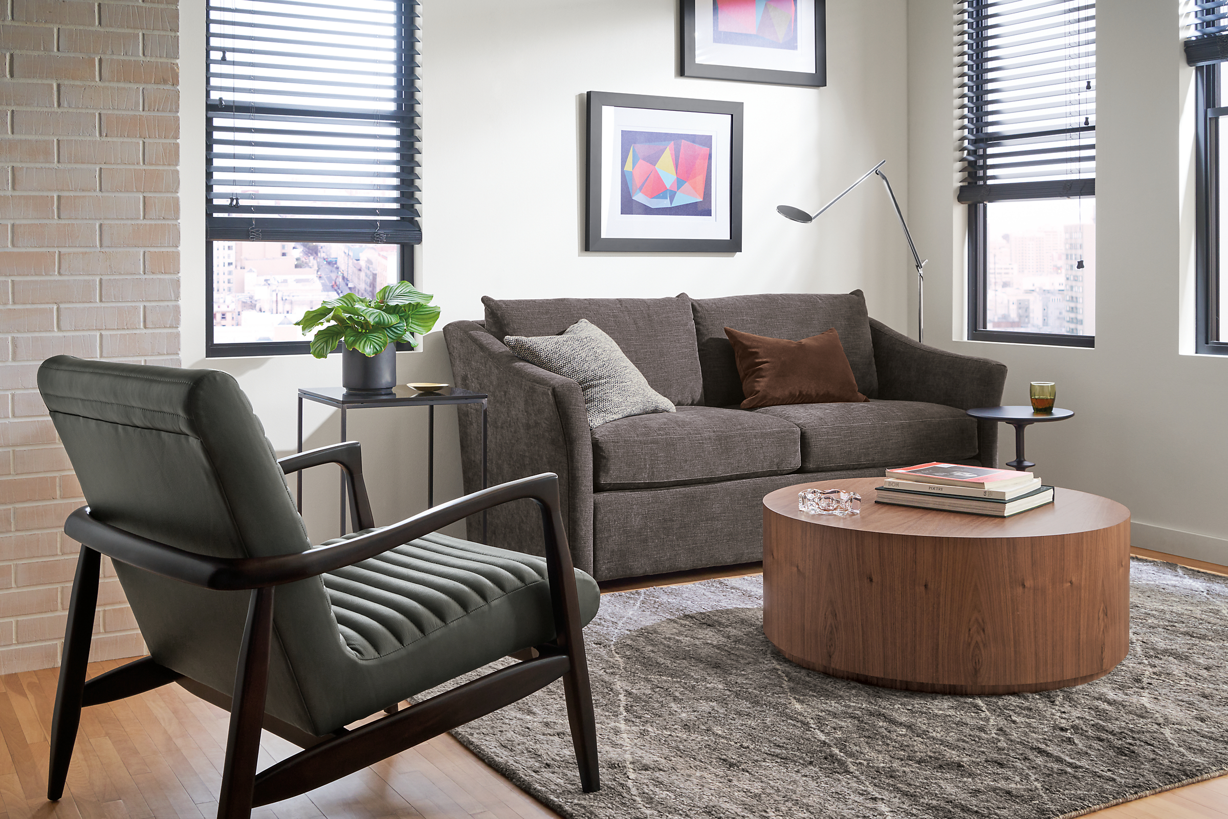 small living room with maeve loveseat in mori charcoal, callan chair in laino slate leather and liam coffee table in walnut.