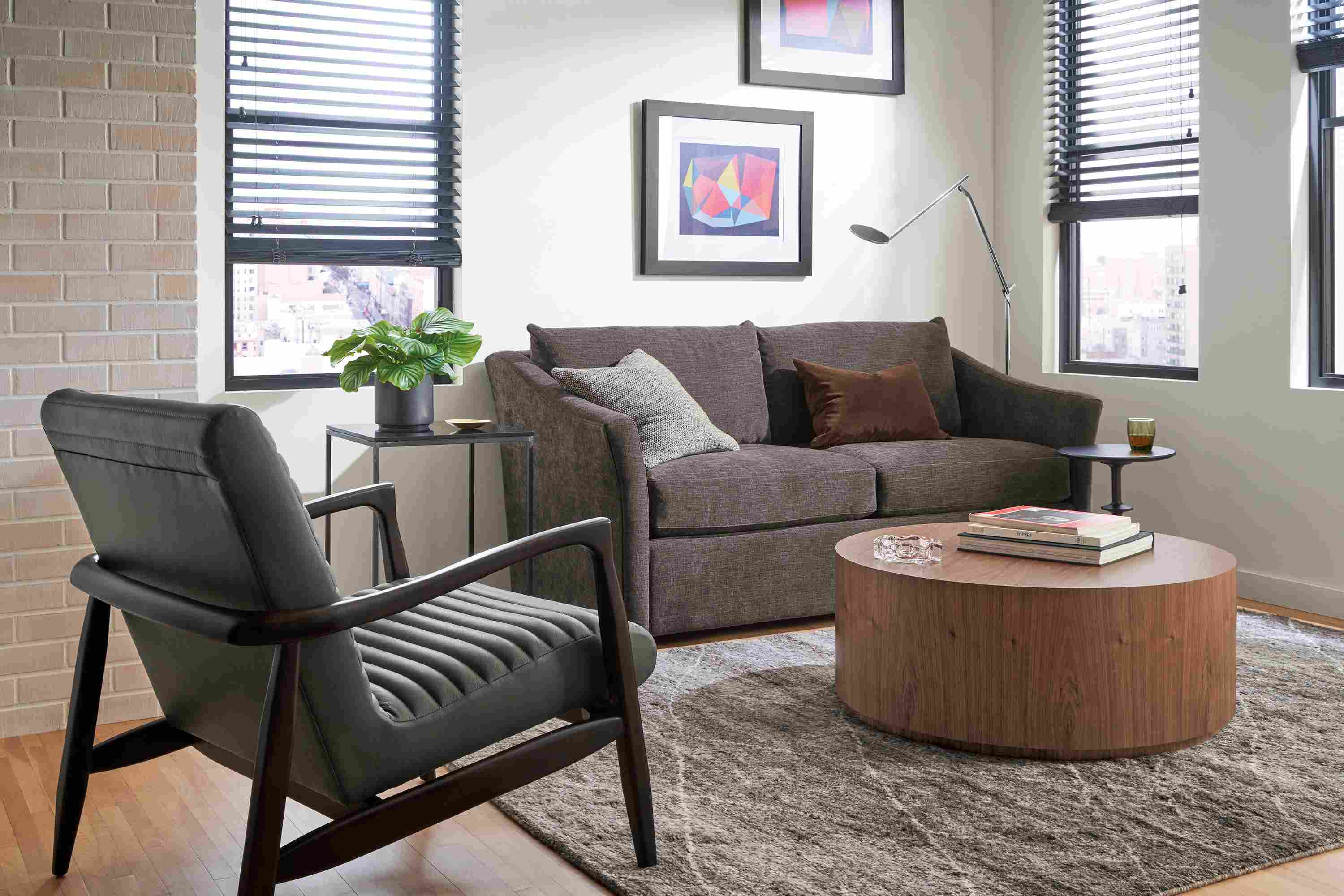 Small living room with Maeve loveseat in Mori charcoal, Callan chair in Laino slate leather and Liam coffee table in walnut.