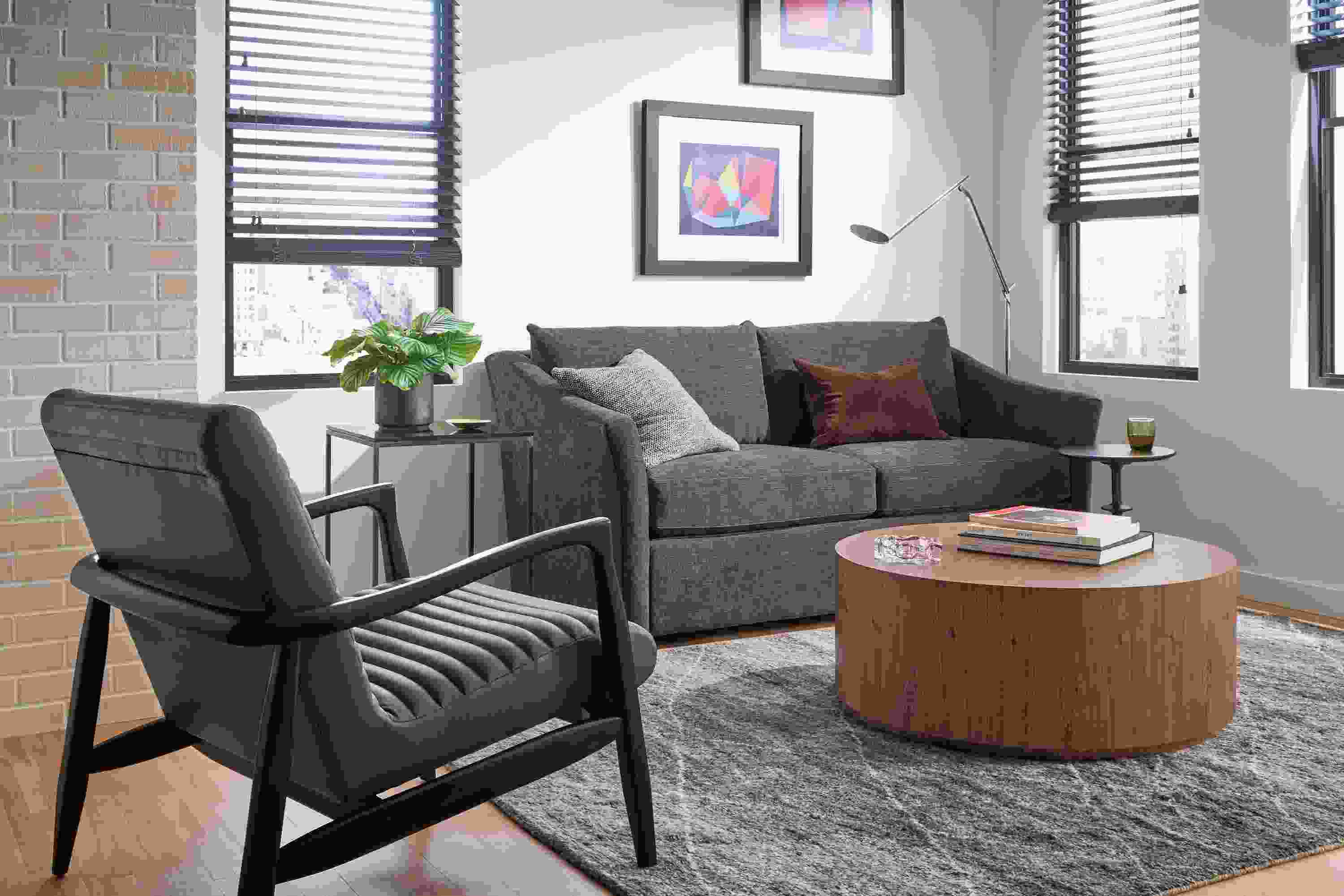 Small living room with Maeve loveseat in Mori charcoal, Callan chair in Laino slate leather and Liam coffee table in walnut.