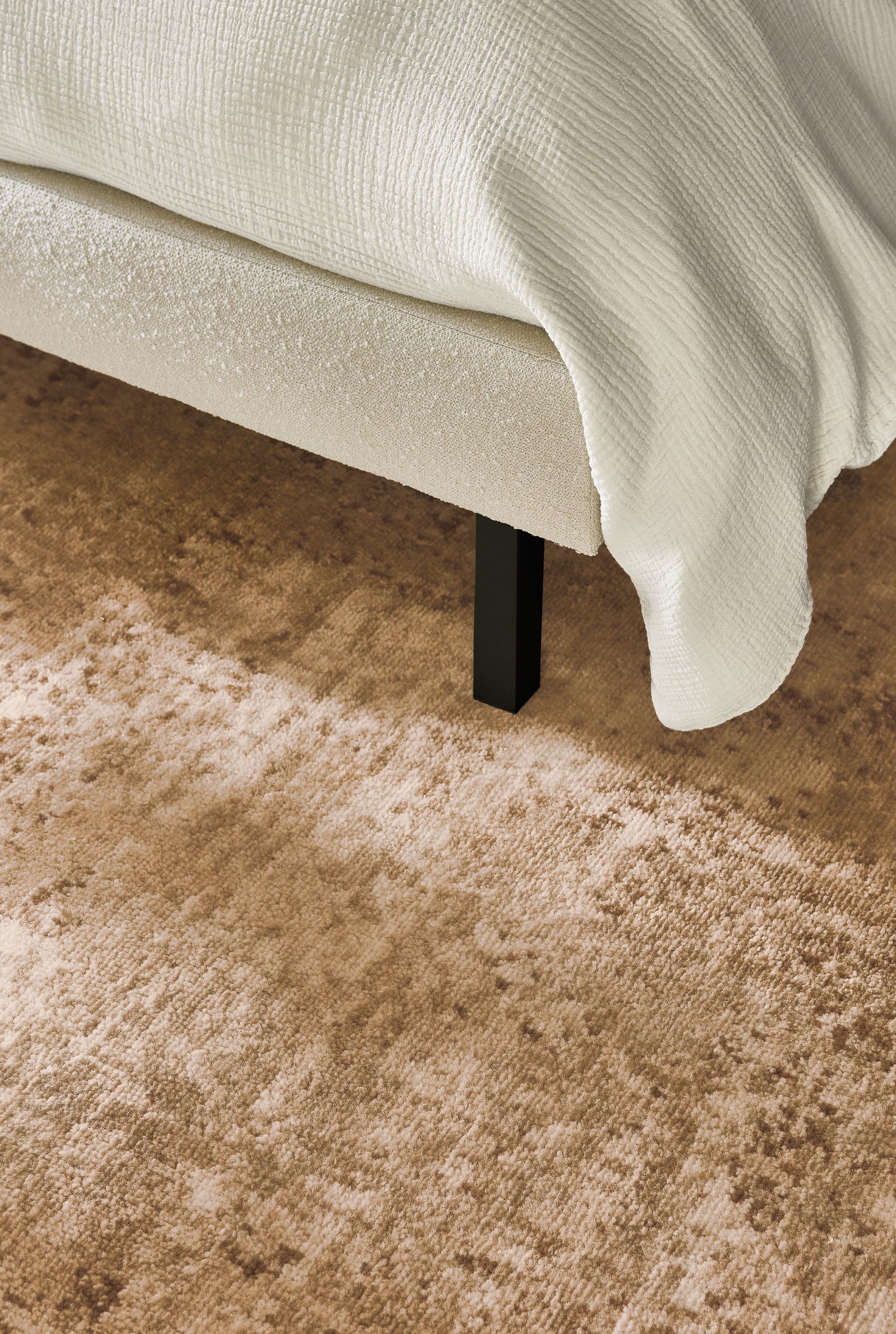 Detail of Makali 8 by 10 rug stone and Ella queen bed in Declan Ivory.