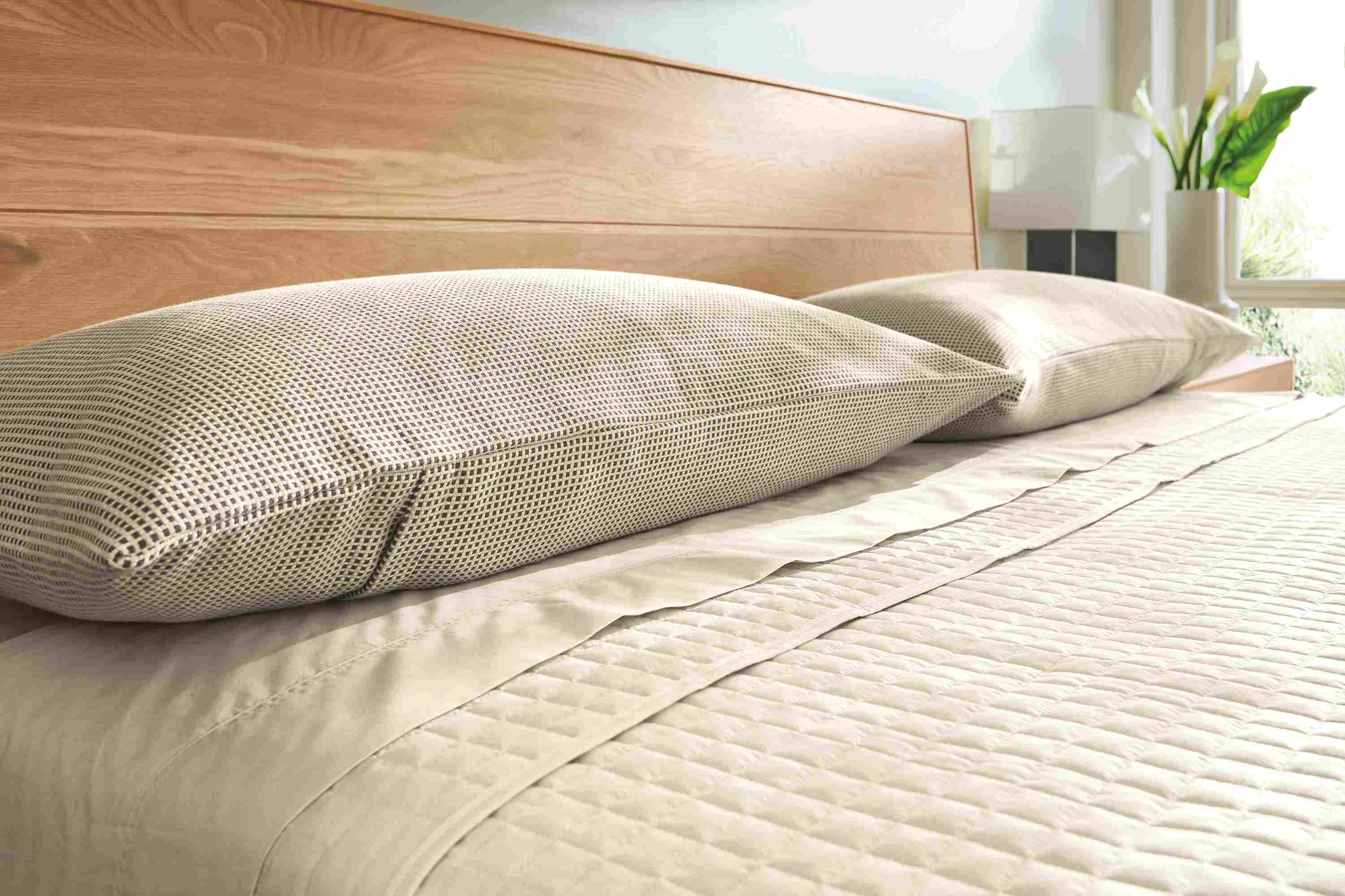 Bedroom with detail of Mara king sham in ivory/grey and signature percale sheets and coverlet in Ecru.