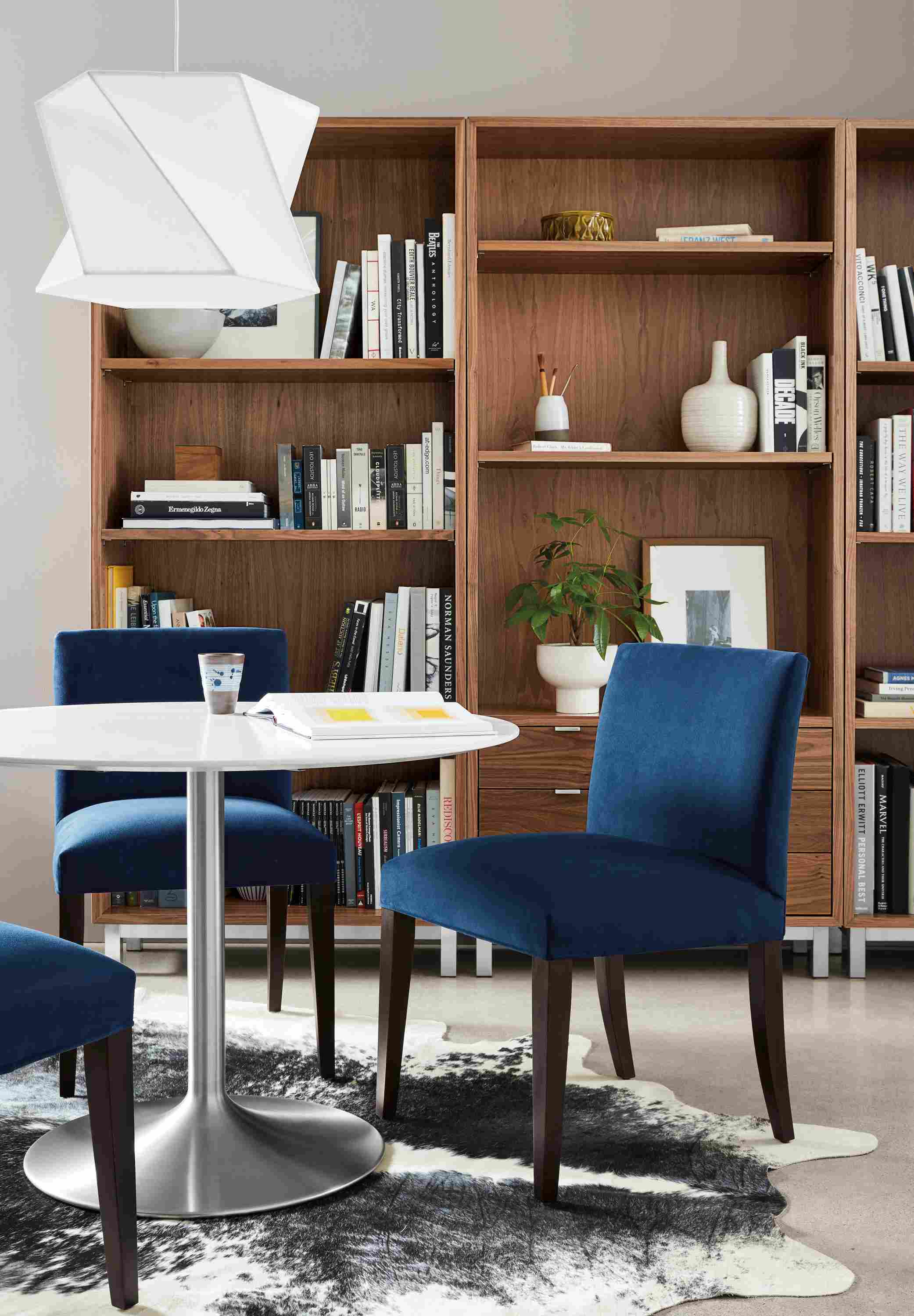 Cozy nook with 3 Marie side chairs in view indigo and an Aria table in stainless with white MDF top.