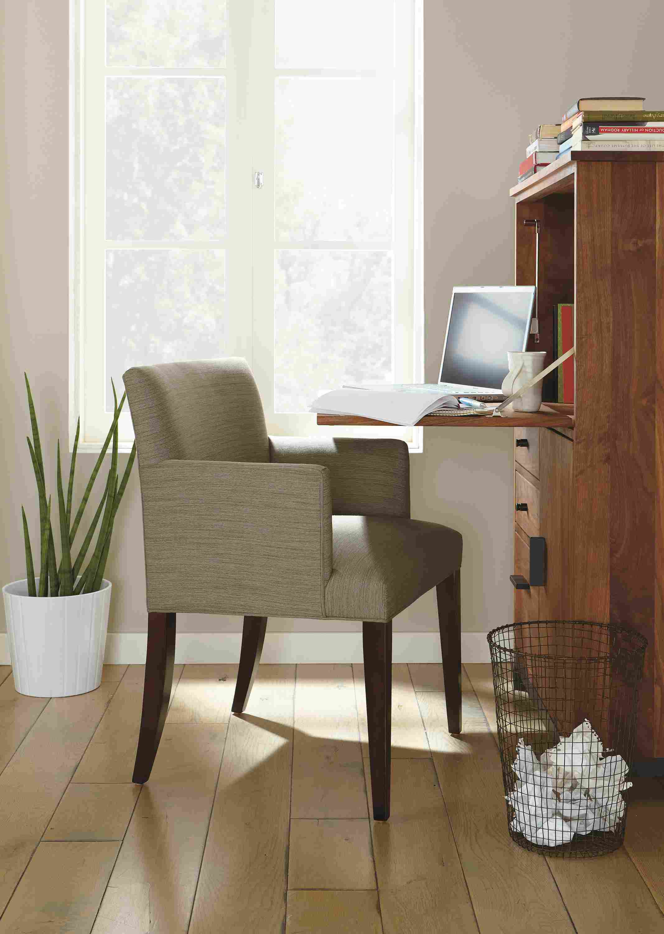 Home office with Marie arm chair and Linear office armoirs in natural steel and walnut.