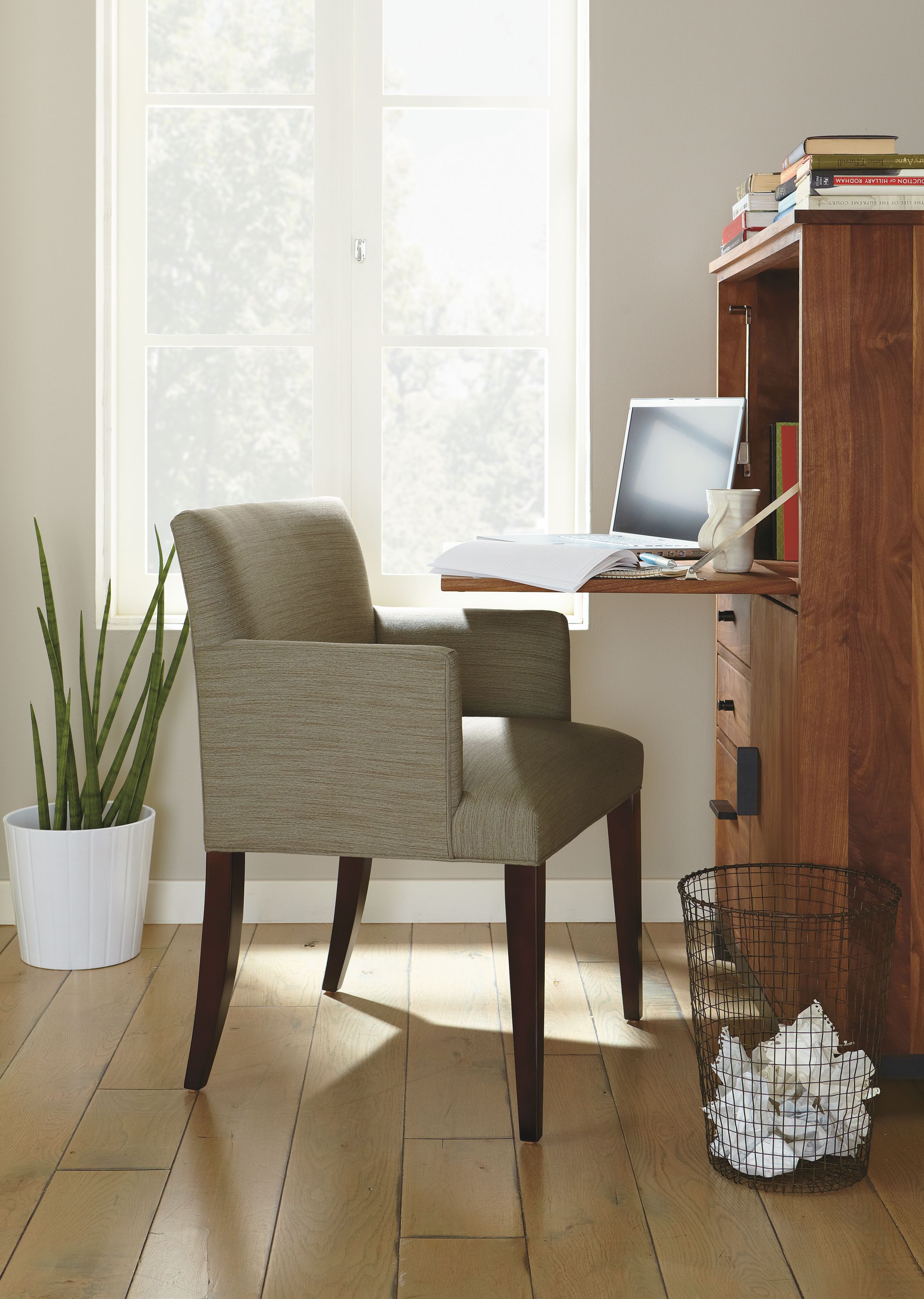 Home office with Marie arm chair and Linear office armoirs in natural steel and walnut.