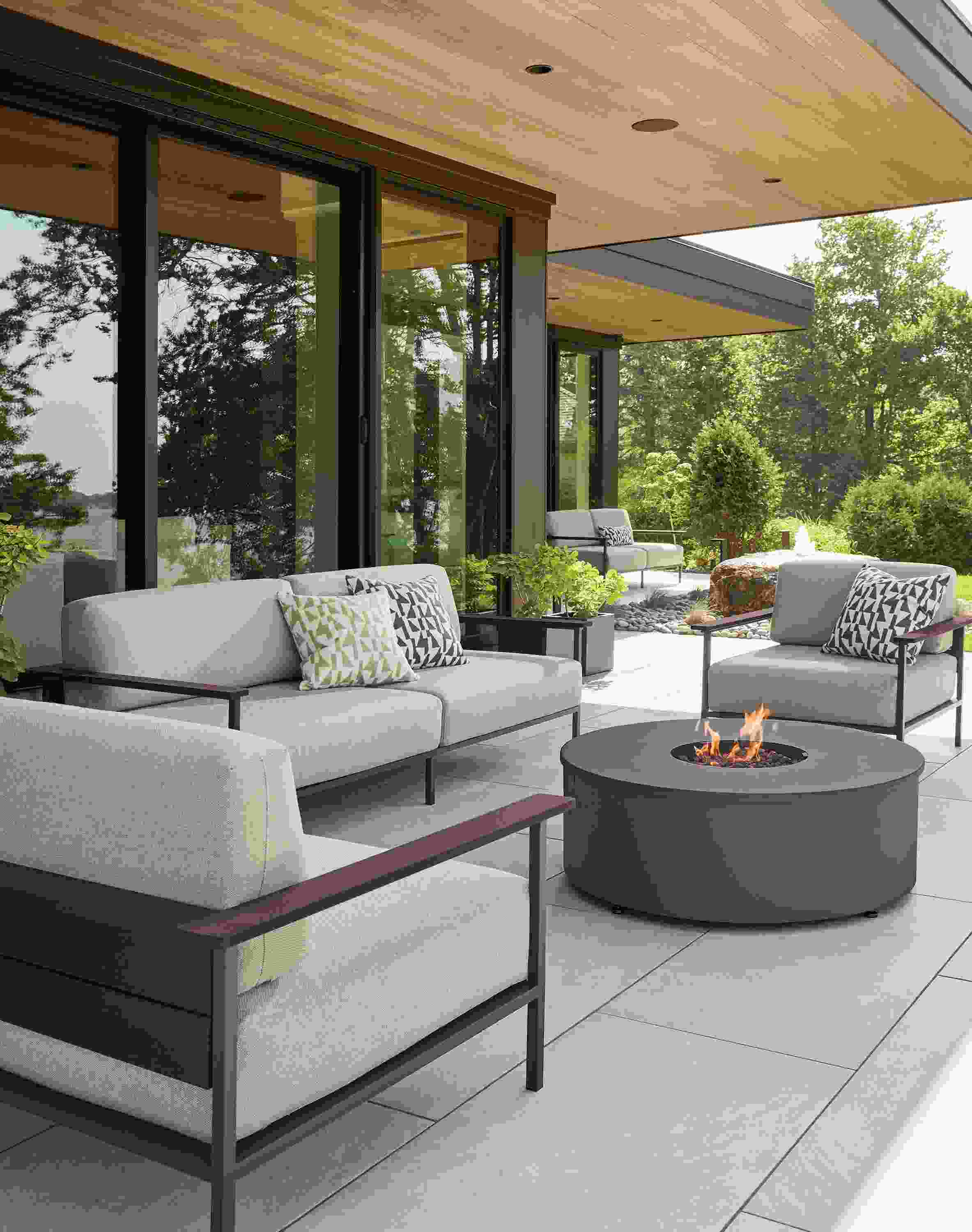 Patio with Marin lounge chairs and sofas in Mist Oatmeal and thermally modified oak and graphite.