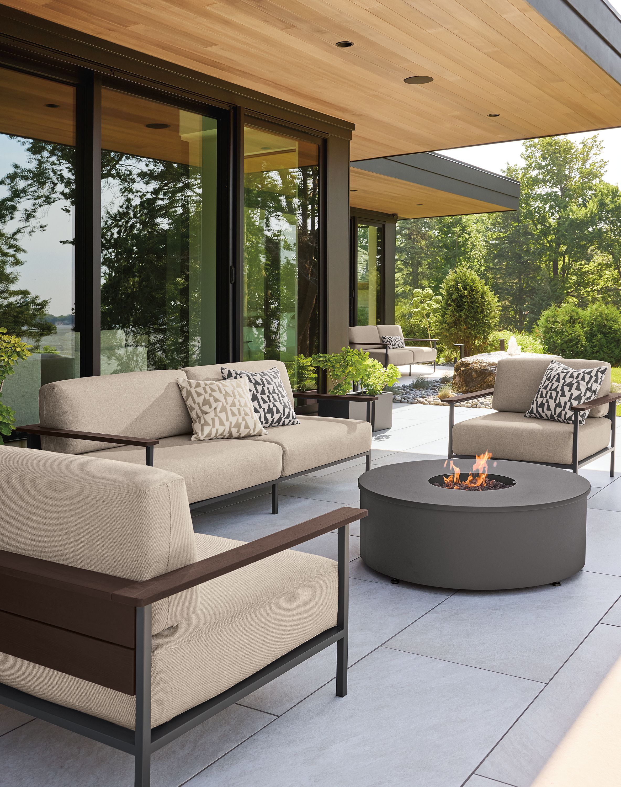 Patio with Marin lounge chairs and sofas in Mist Oatmeal and thermally modified oak and graphite.