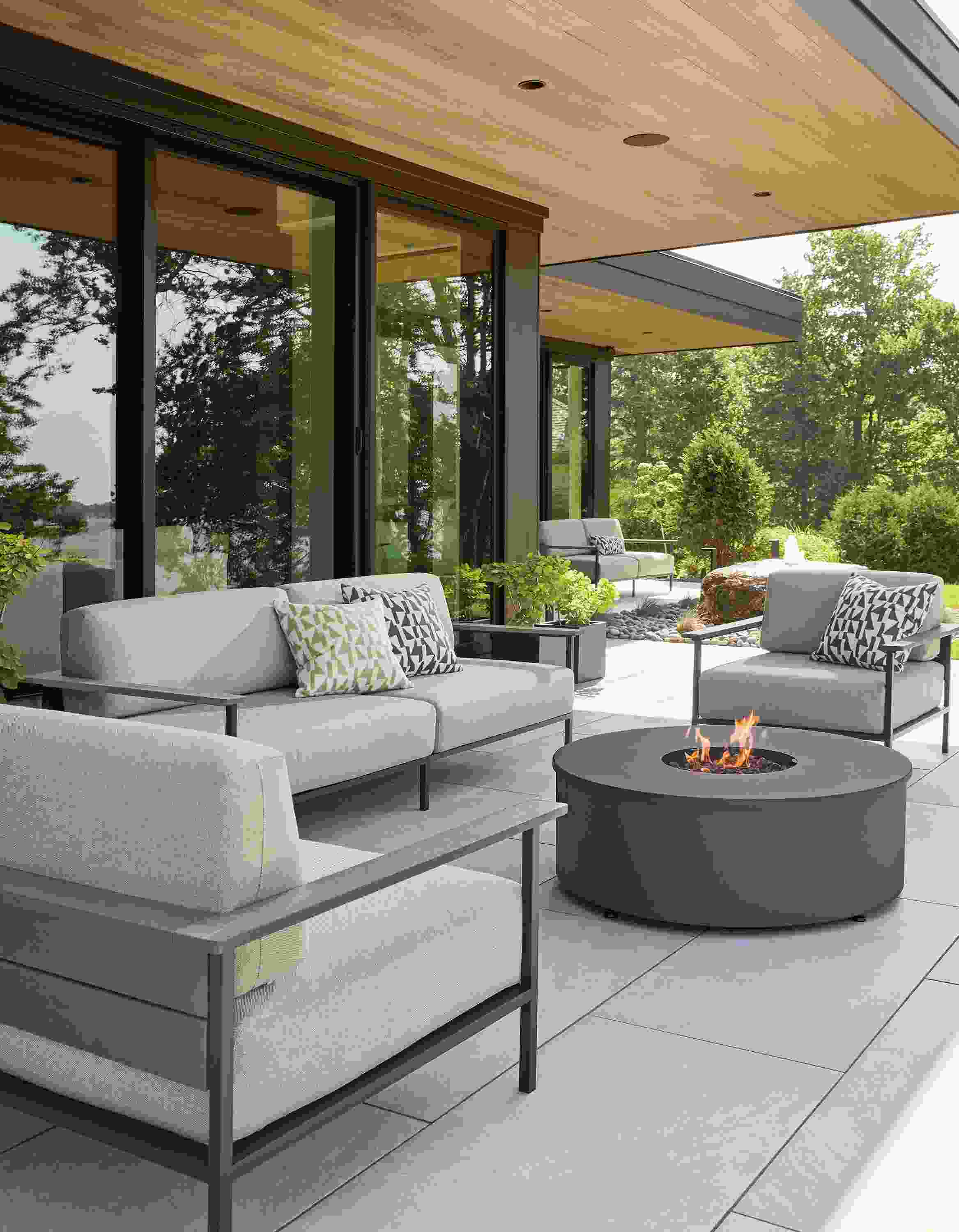 Patio with Marin lounge chairs and sofas in Mist Oatmeal and aged thermally modified oak and graphite.