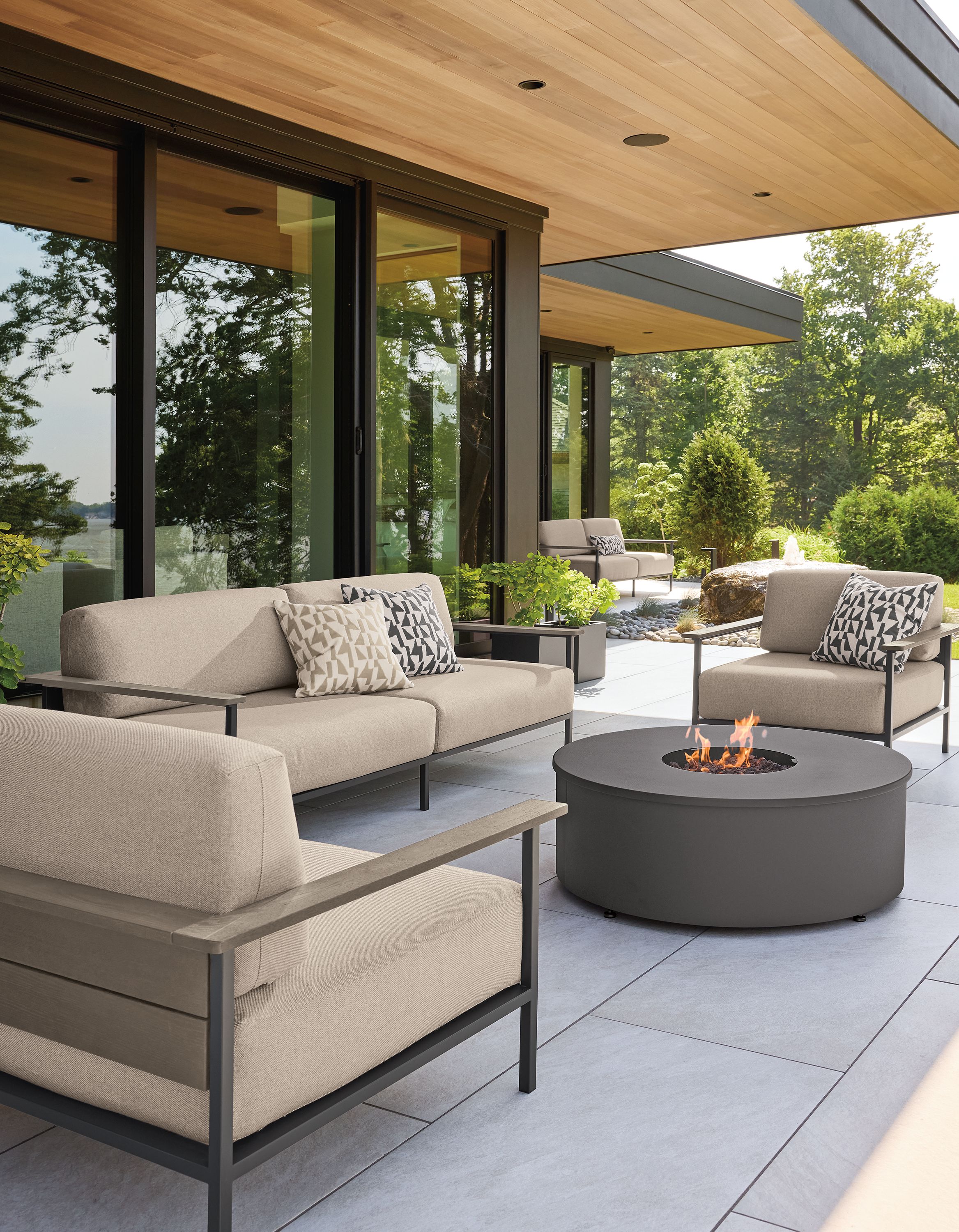 Patio with Marin lounge chairs and sofas in Mist Oatmeal and aged thermally modified oak and graphite.