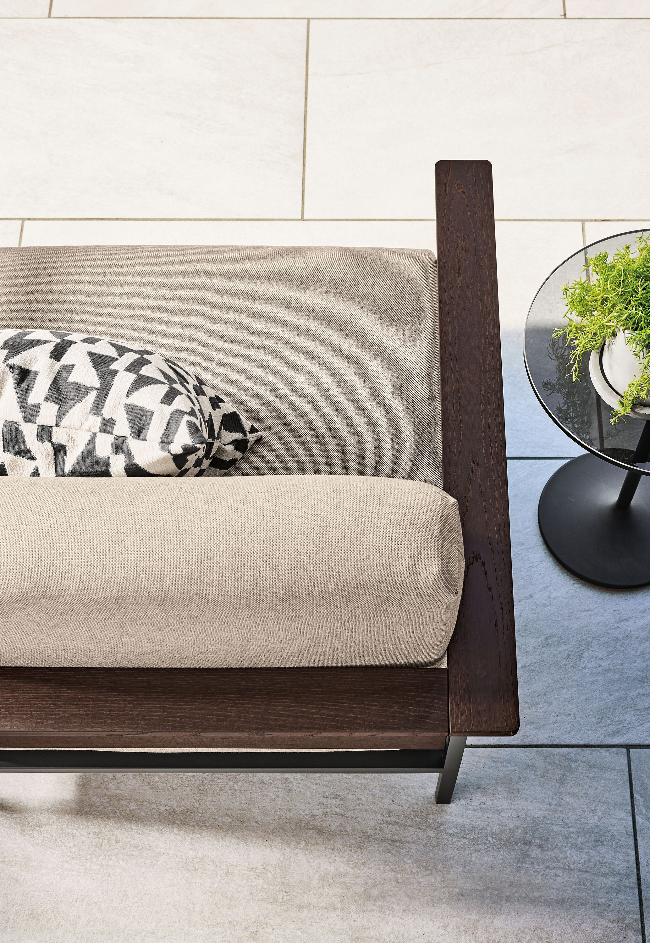 Overhead view of Marin sofa in Mist Oatmeal and thermally modified oak with graphite on a patio.