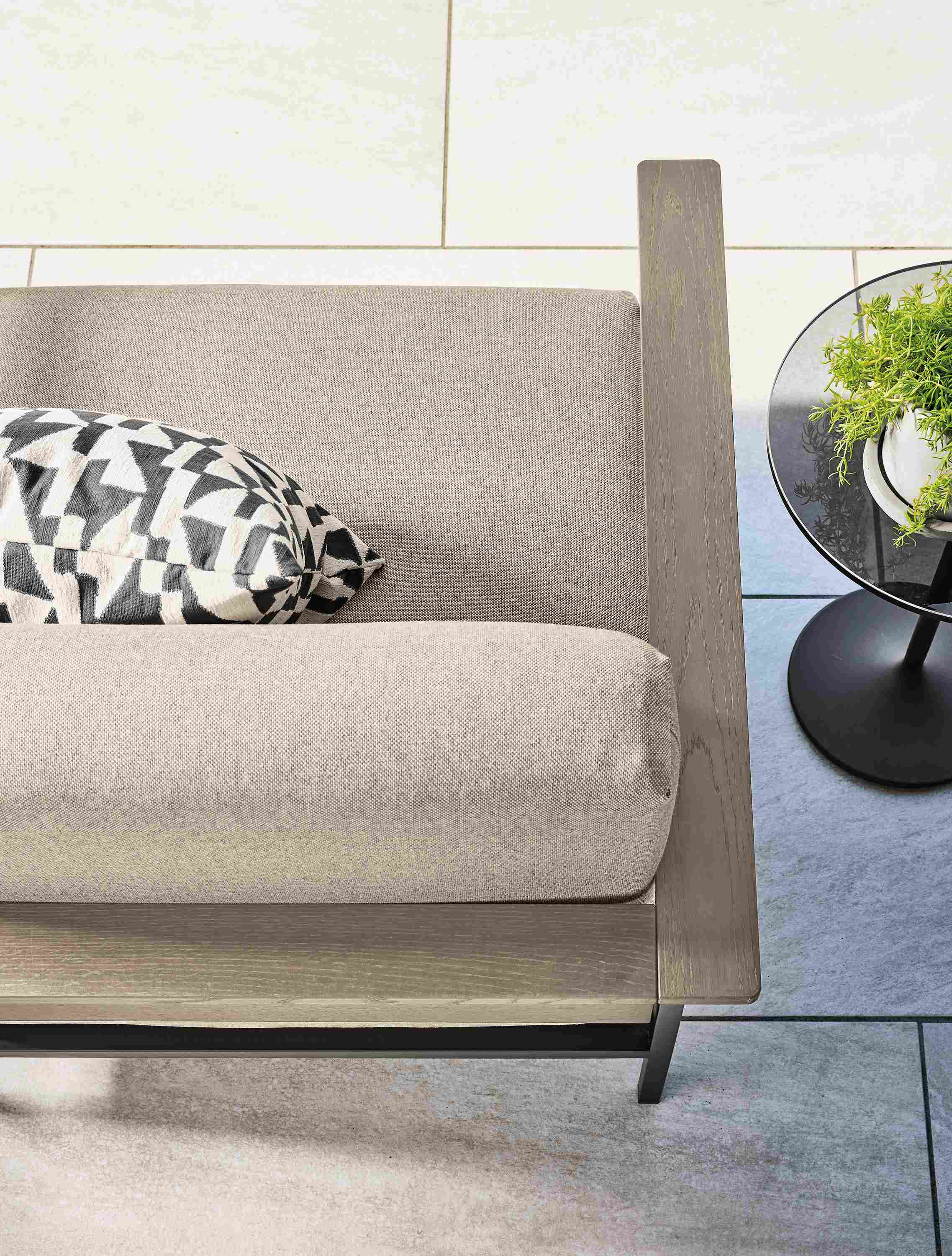 Overhead view of Marin sofa in Mist Oatmeal and aged thermally modified oak with graphite on a patio.