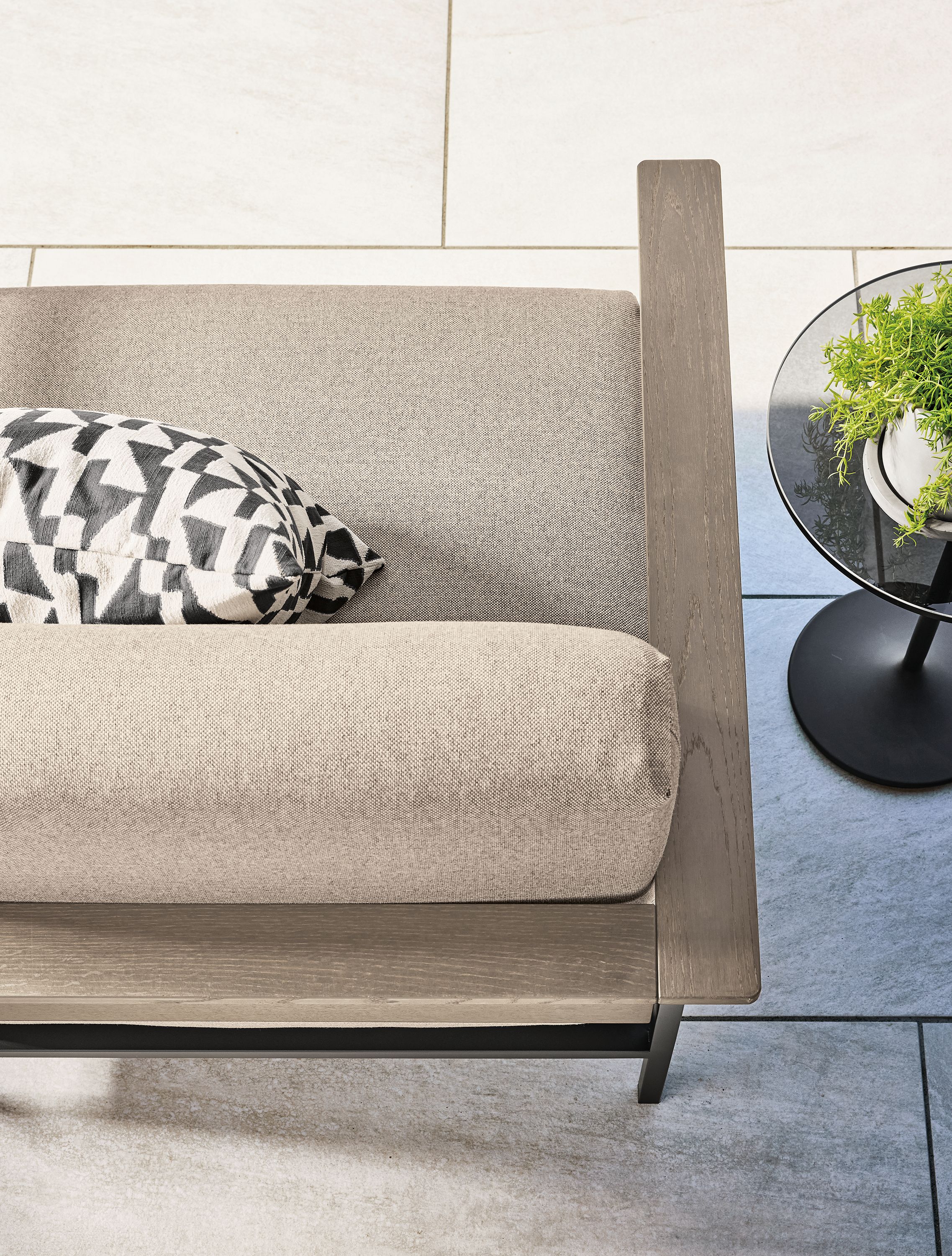 Overhead view of Marin sofa in Mist Oatmeal and aged thermally modified oak with graphite on a patio.