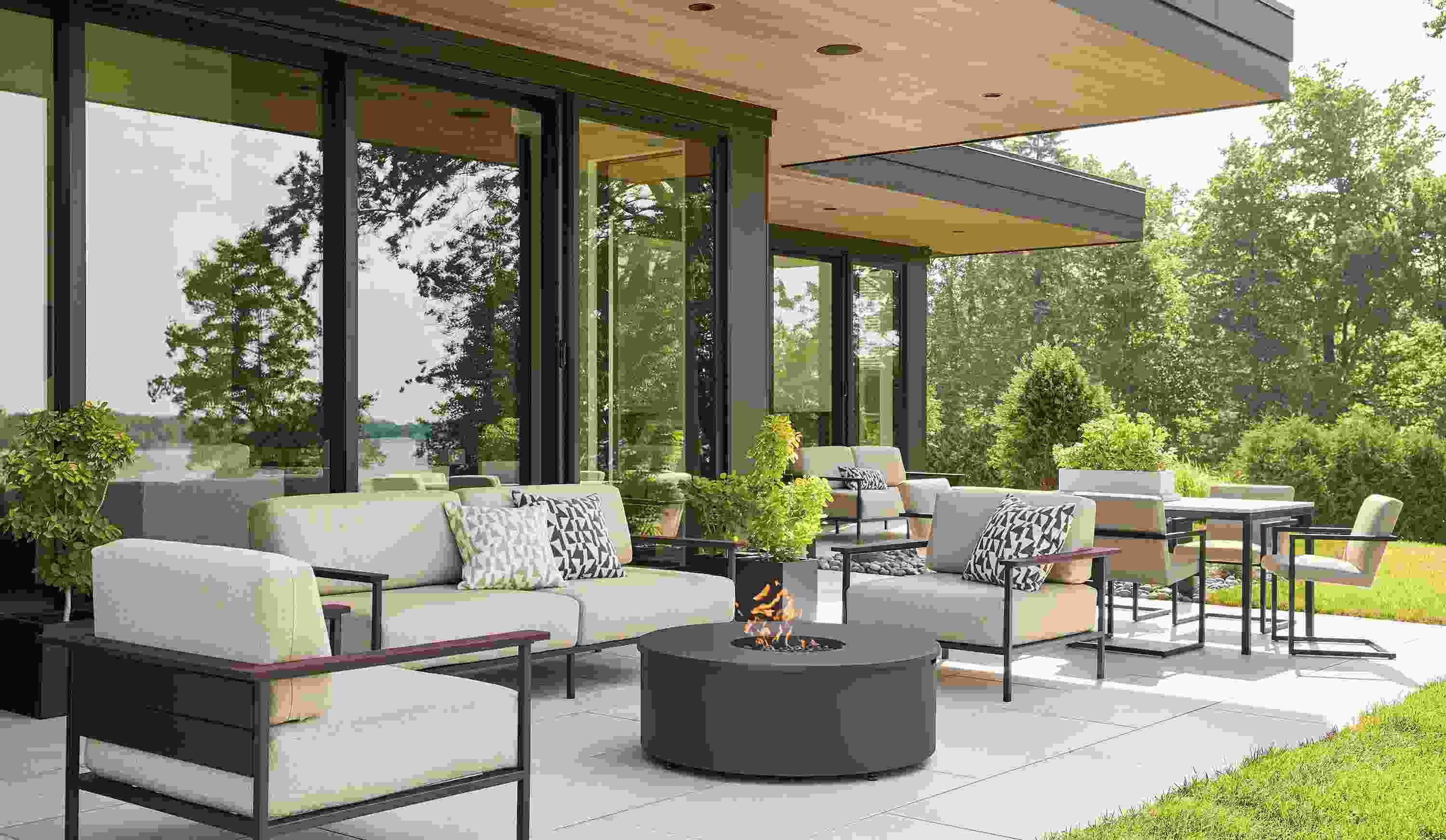 Large home patio with Marin sofas and lounge chairs in mist oatmeal and thermally modified oak and graphite.
