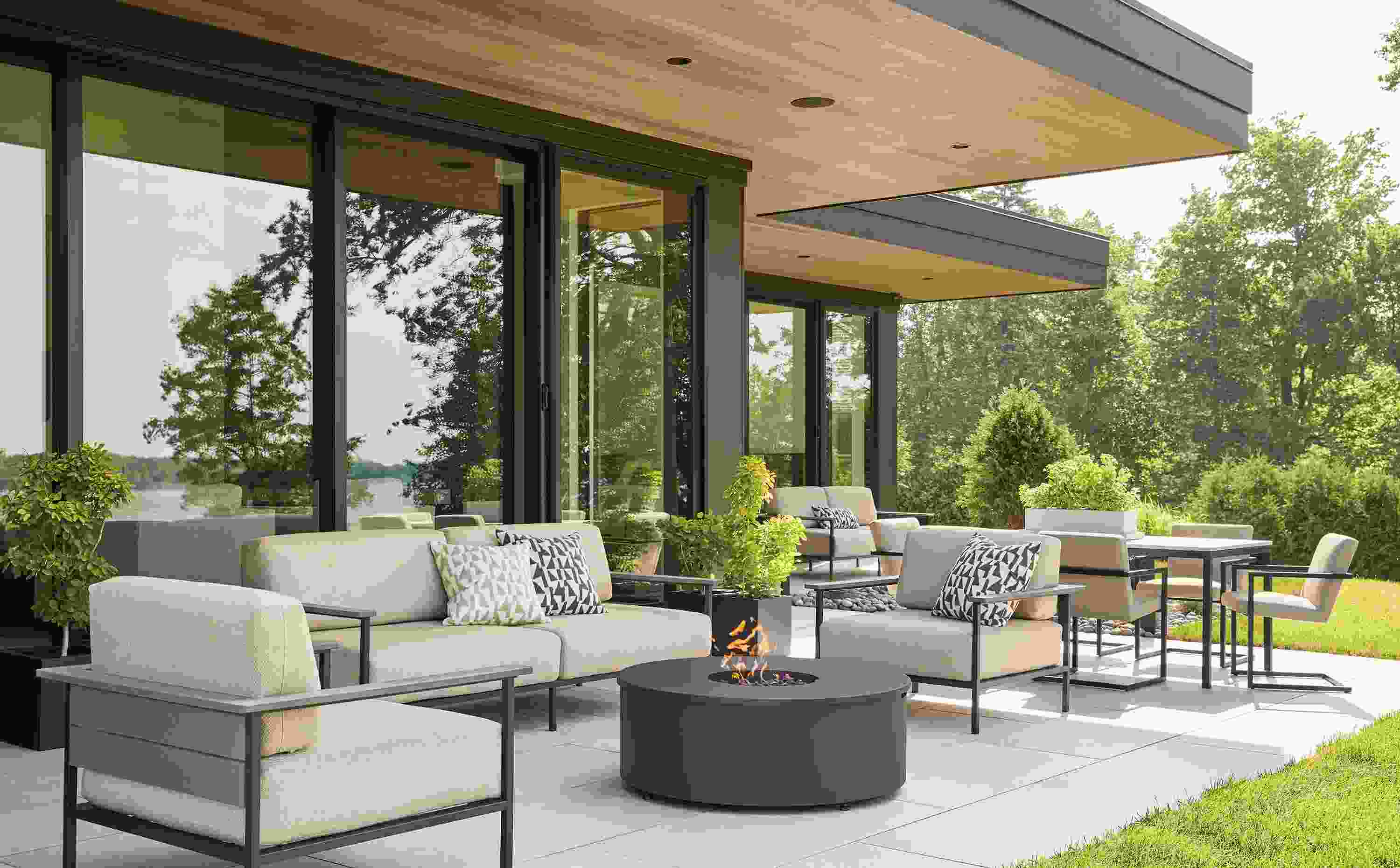 Large home patio with Marin sofas and lounge chairs in mist oatmeal and aged thermally modified oak and graphite.