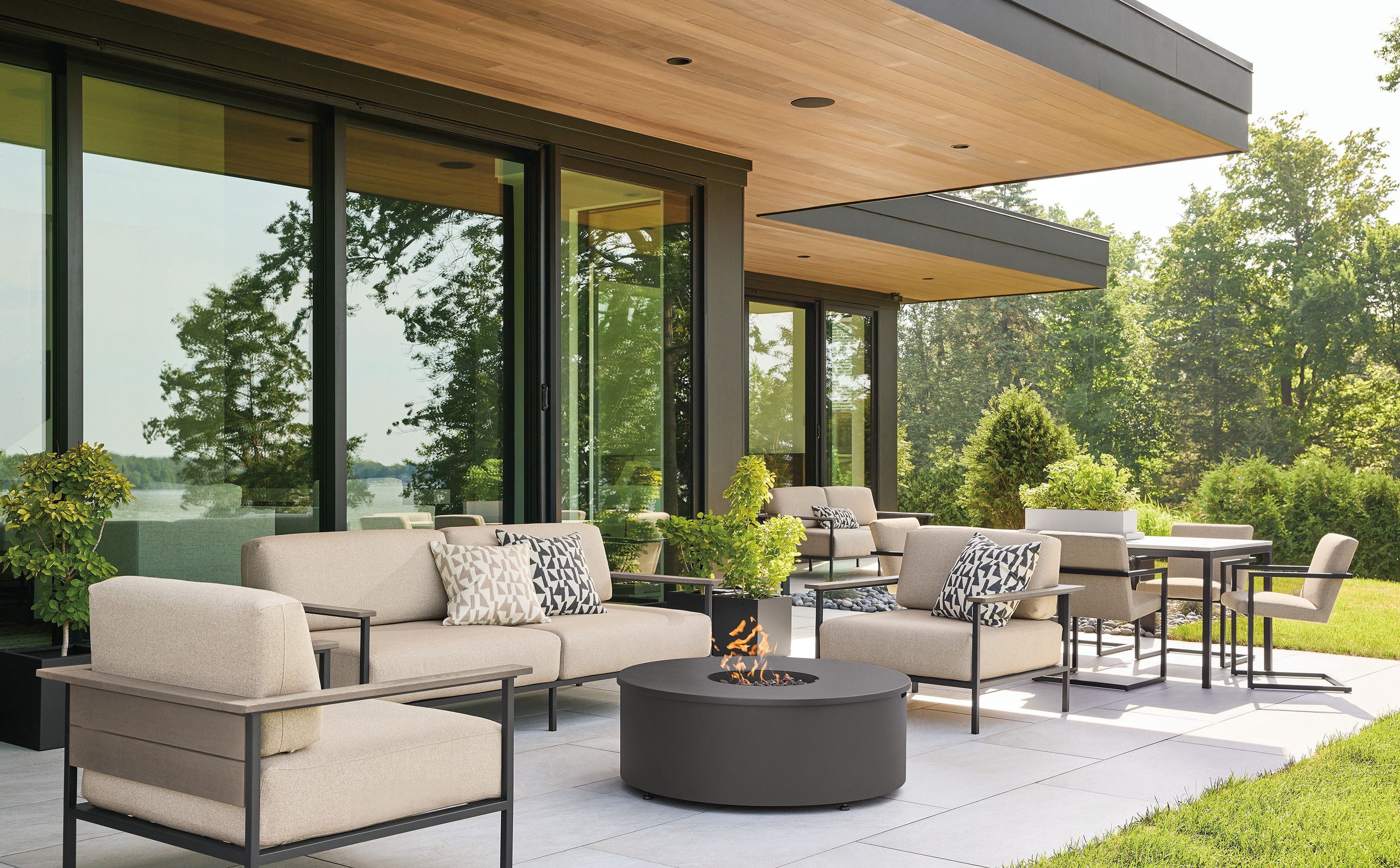 Large home patio with Marin sofas and lounge chairs in mist oatmeal and aged thermally modified oak and graphite.
