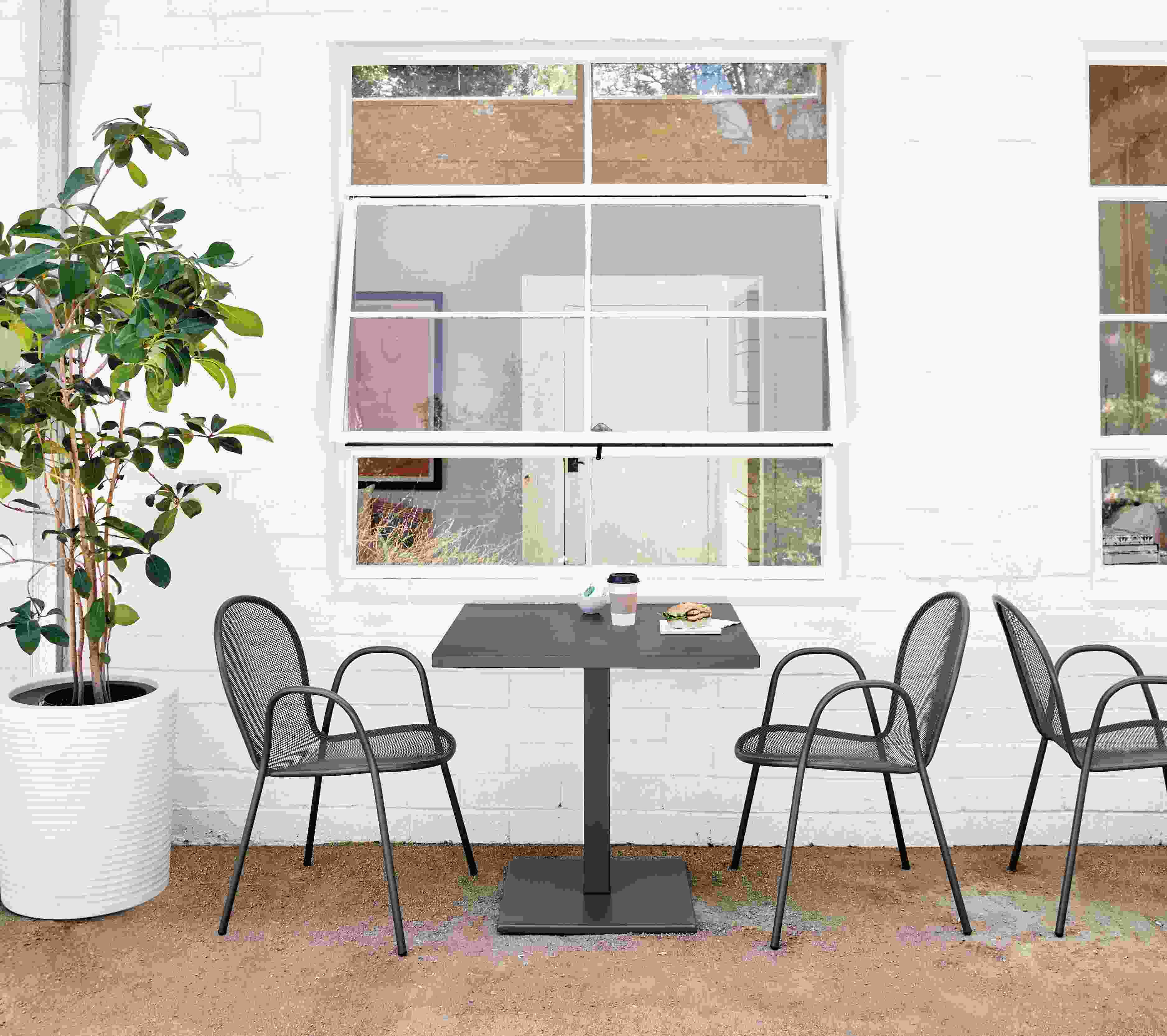 Detail of Maris square table and Rio chairs in graphite.