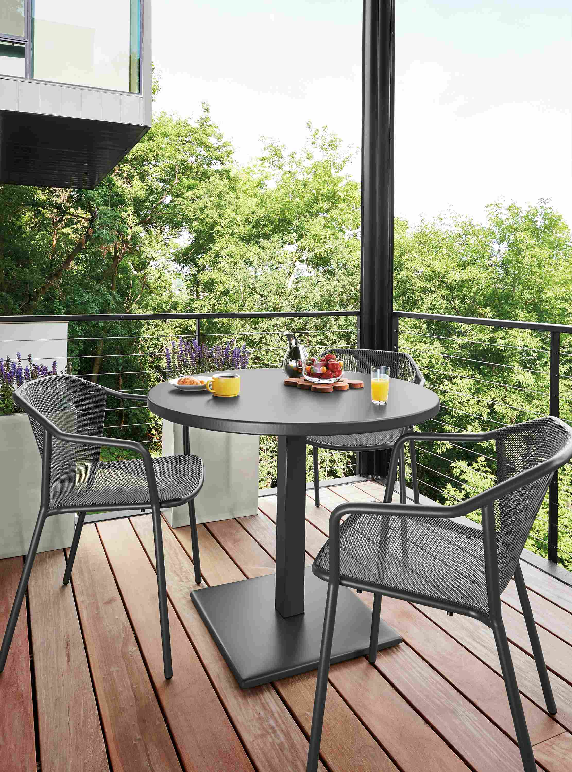 Detail of Maris outdoor round patio table and Theo chairs all in graphite.