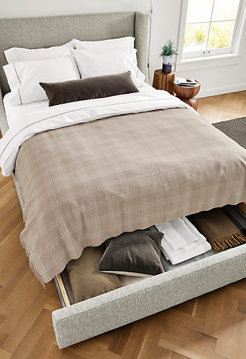 Detail of Marlo queen storage bed in Tepic Cement fabric with storage drawer opened.