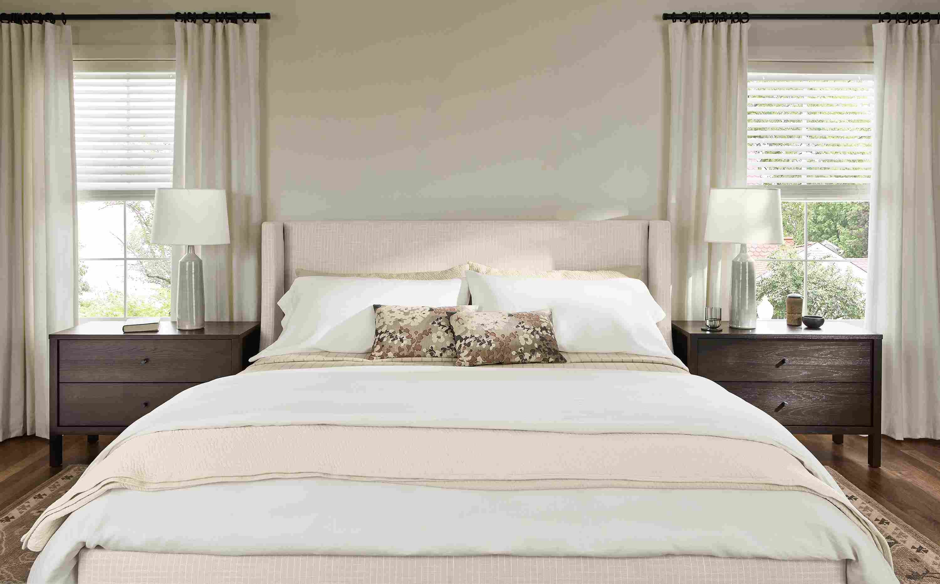 Bedroom with detail of Marlo king storage bed in Prado Natural and 2 Emerson nightstands in charcoal.