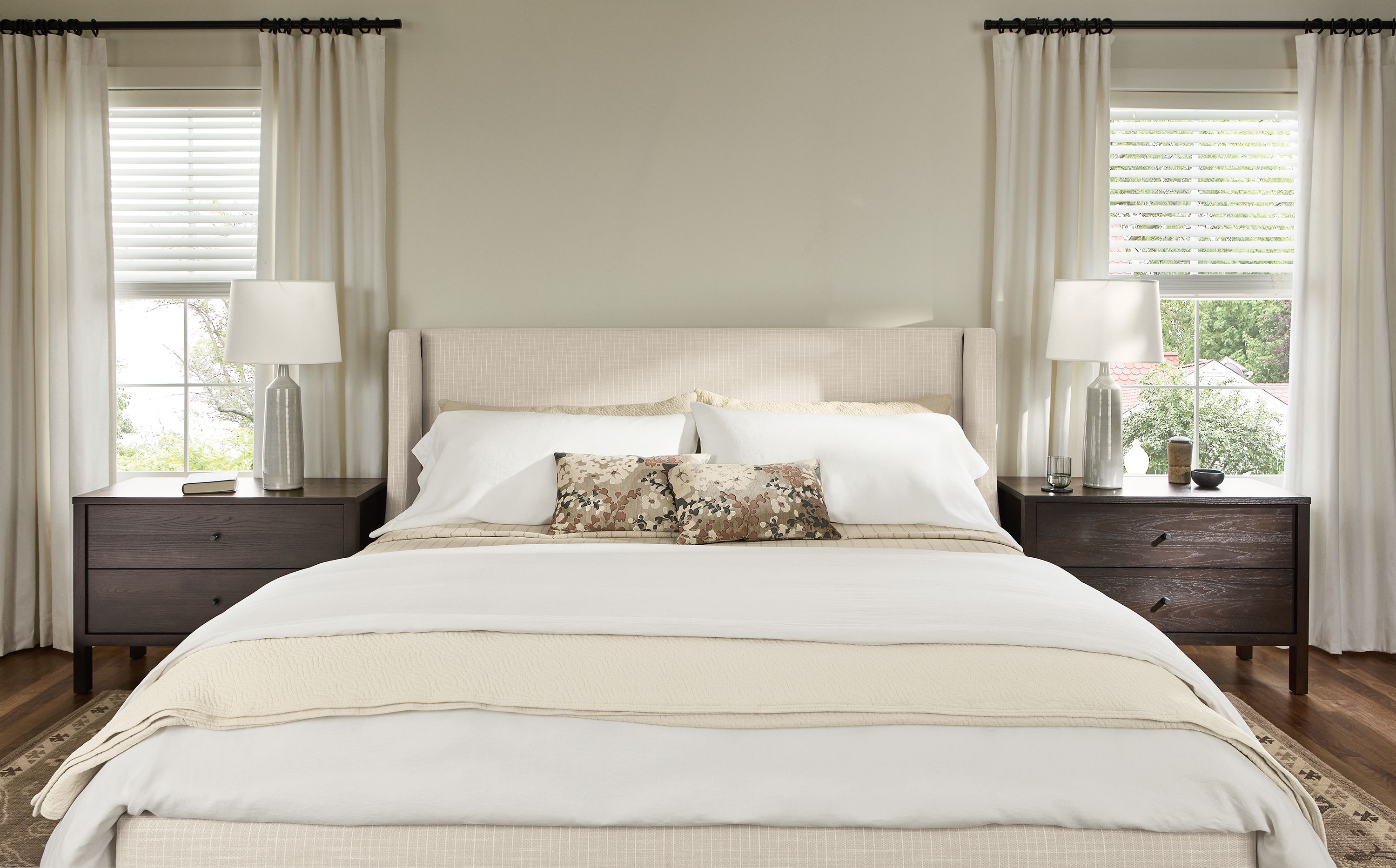 Bedroom with detail of Marlo king storage bed in Prado Natural and 2 Emerson nightstands in charcoal.