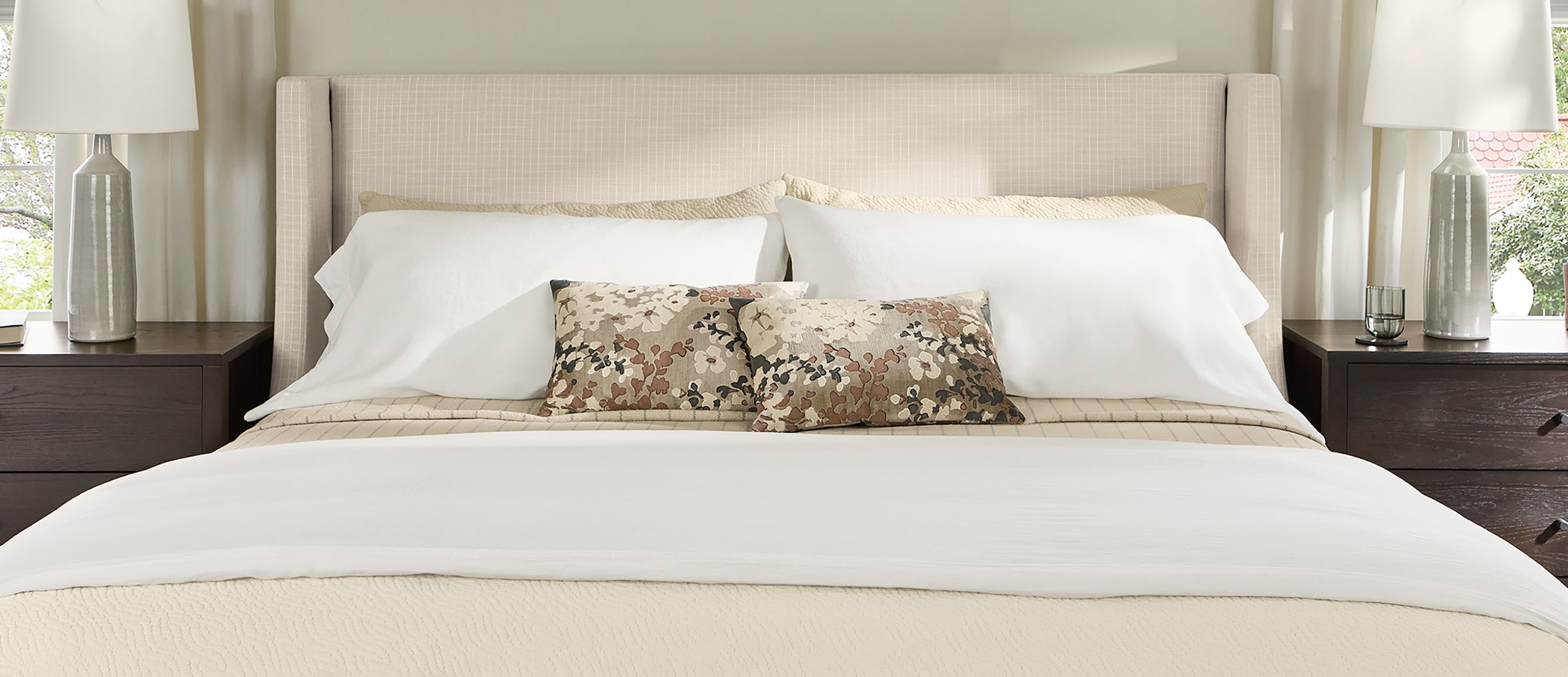 Bedroom with detail of Marlo king storage bed in Prado Natural and 2 Emerson nightstands in charcoal.