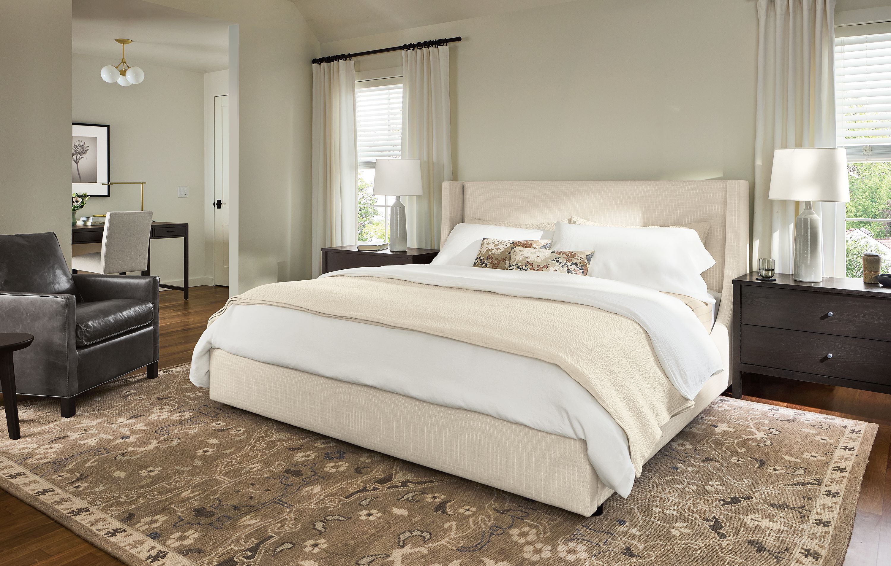 Bedroom with Marlo king storage bed in Prado Natural and Bram chair in Vento Smoke leather.