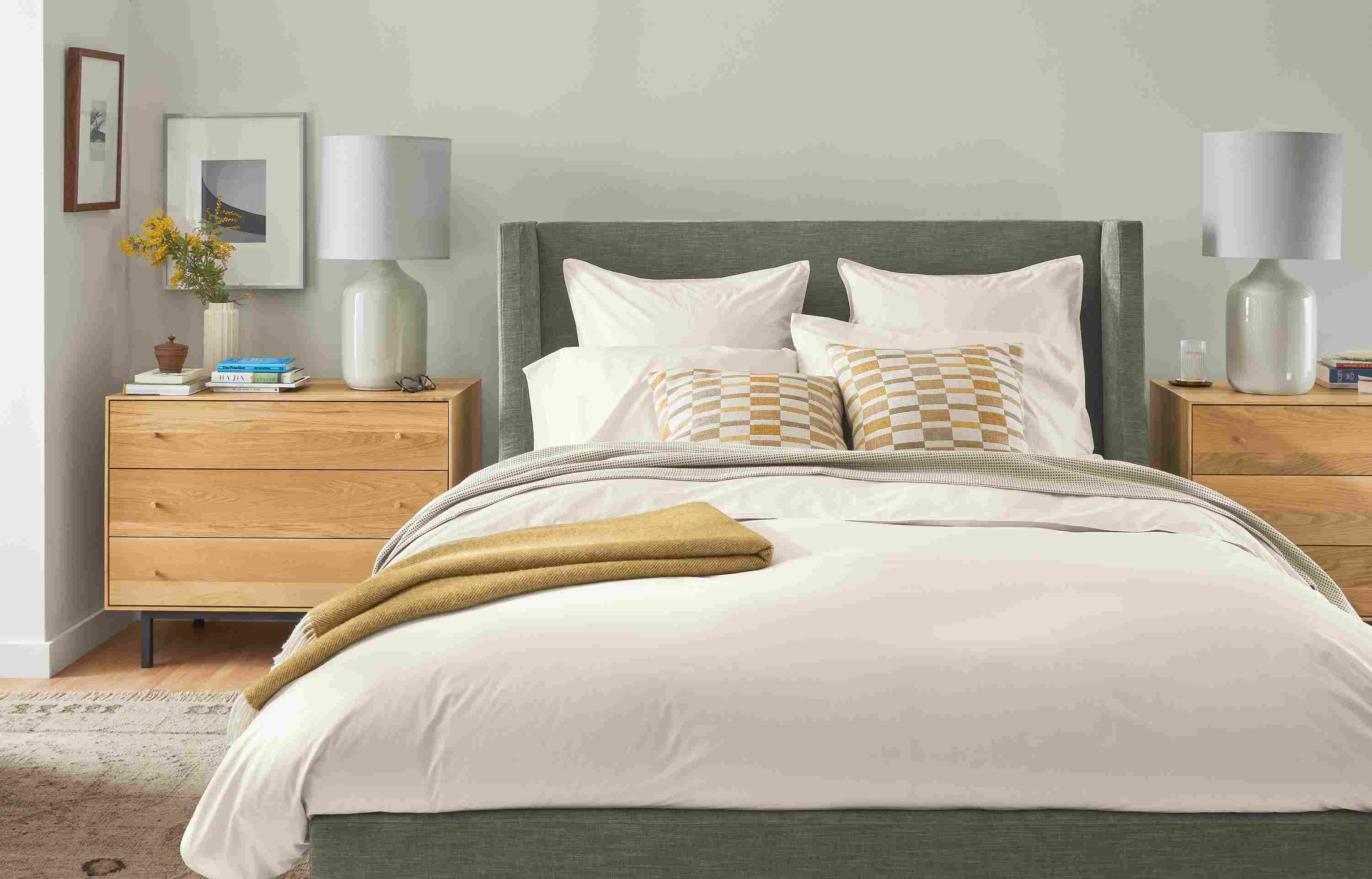 Bedroom with front view of Marlo queen storage bed in Mori Graphite, Hudson dressers and Serena lamps.