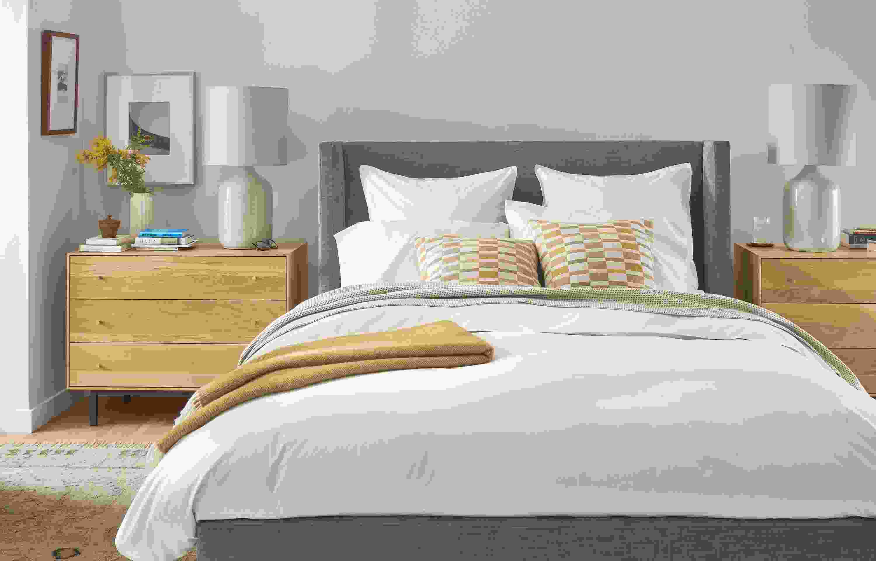 Bedroom with front view of Marlo queen storage bed in Mori Graphite, Hudson dressers and Serena lamps.