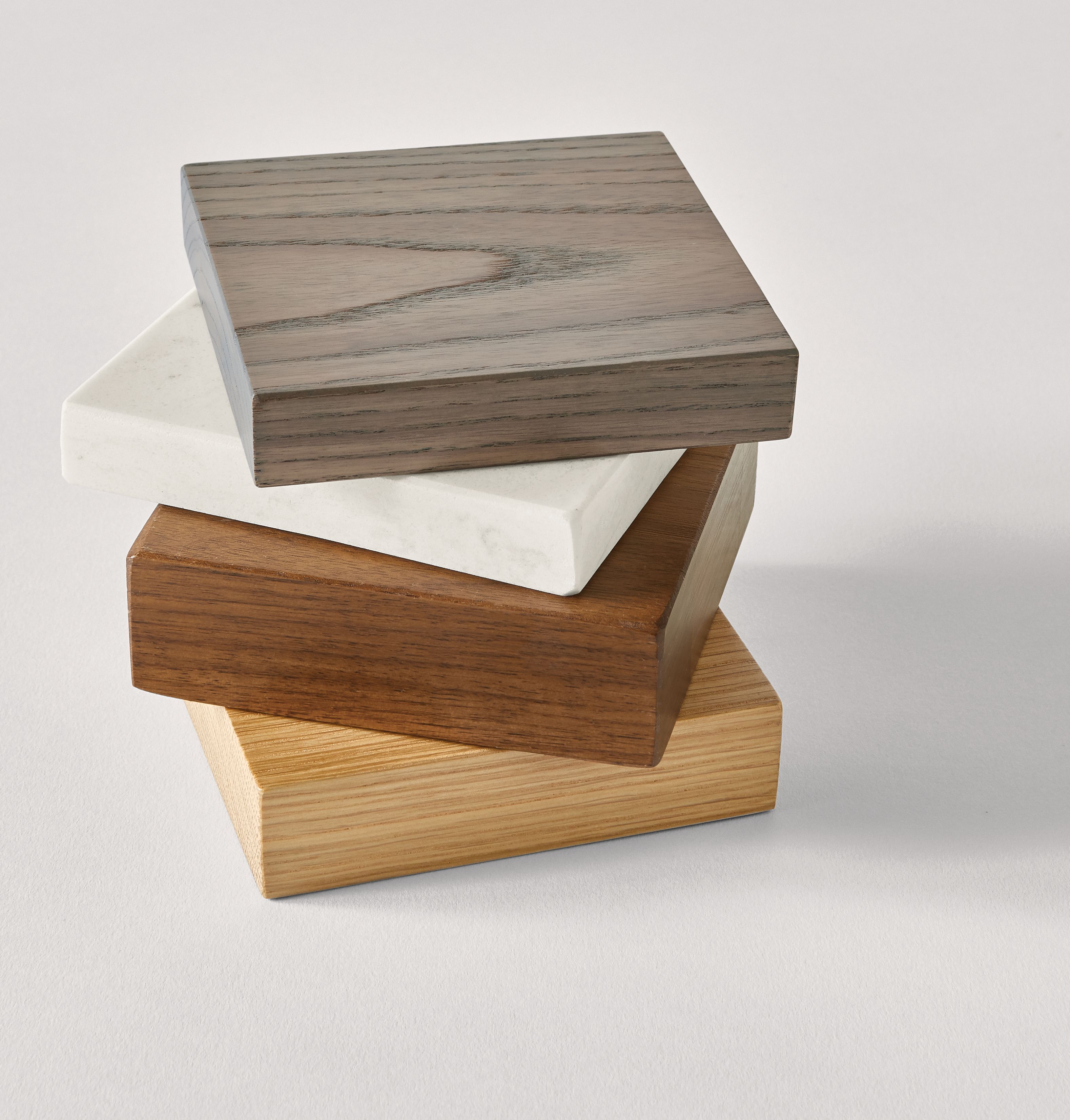 material collage including ash wood with shell stain, marbled white quartz, walnut and white oak.