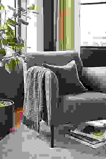 Detail of Matteo chair in flint gunmetal fabric in living room.
