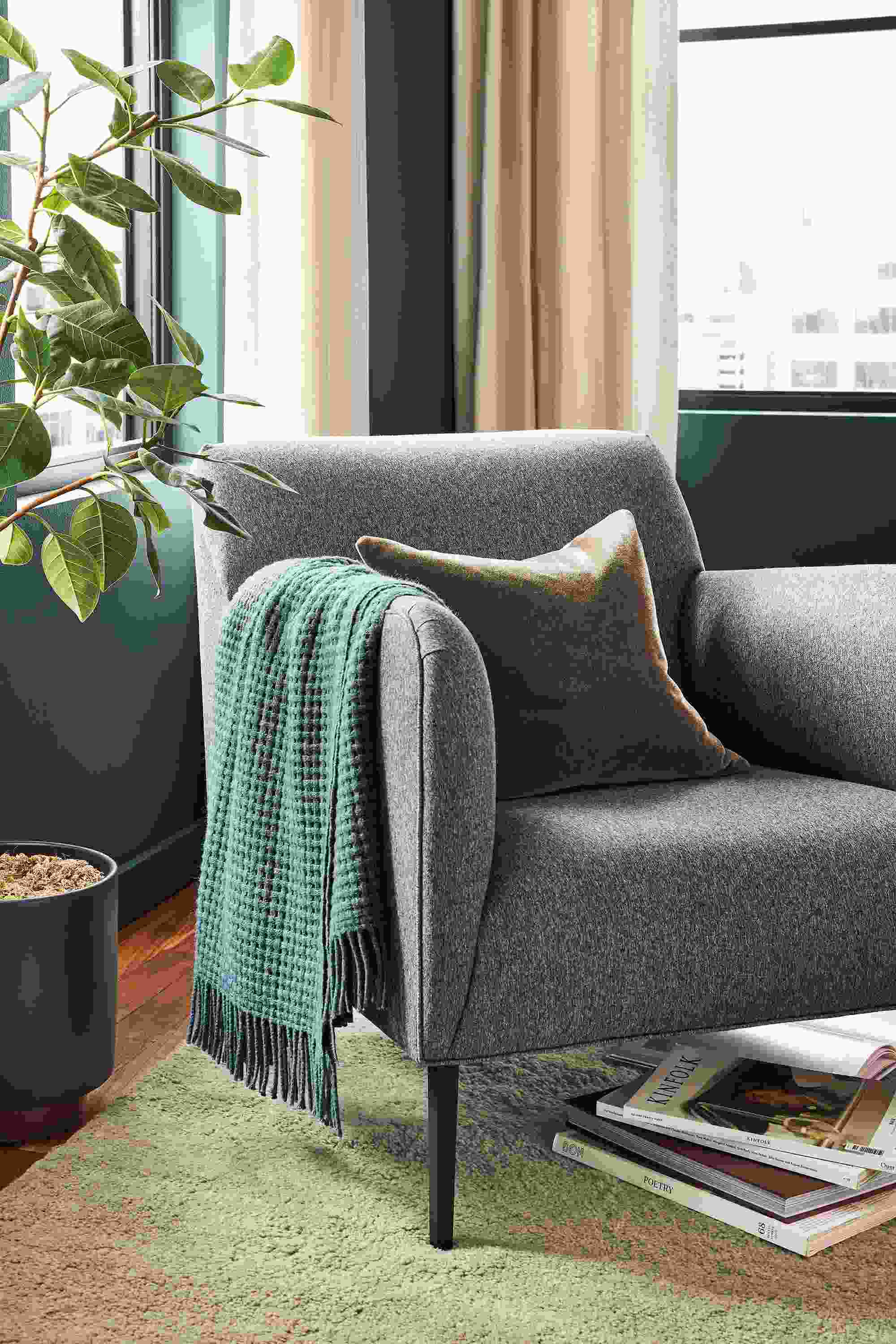 Detail of Matteo chair in flint gunmetal fabric in living room.