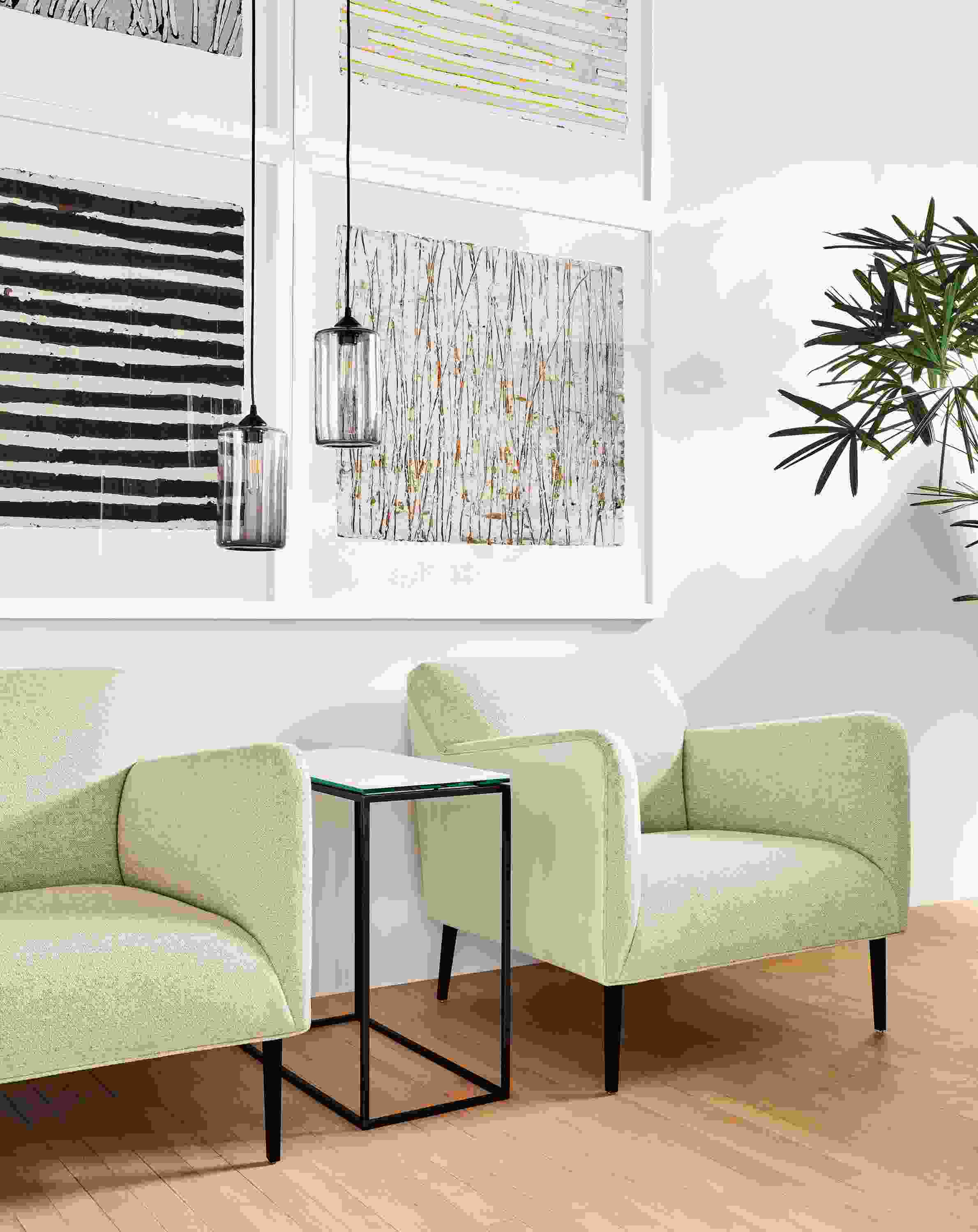 Two Matteo chairs in Tatum Natural with Vento Ivory leather in front of Antje Hassinger wall art.