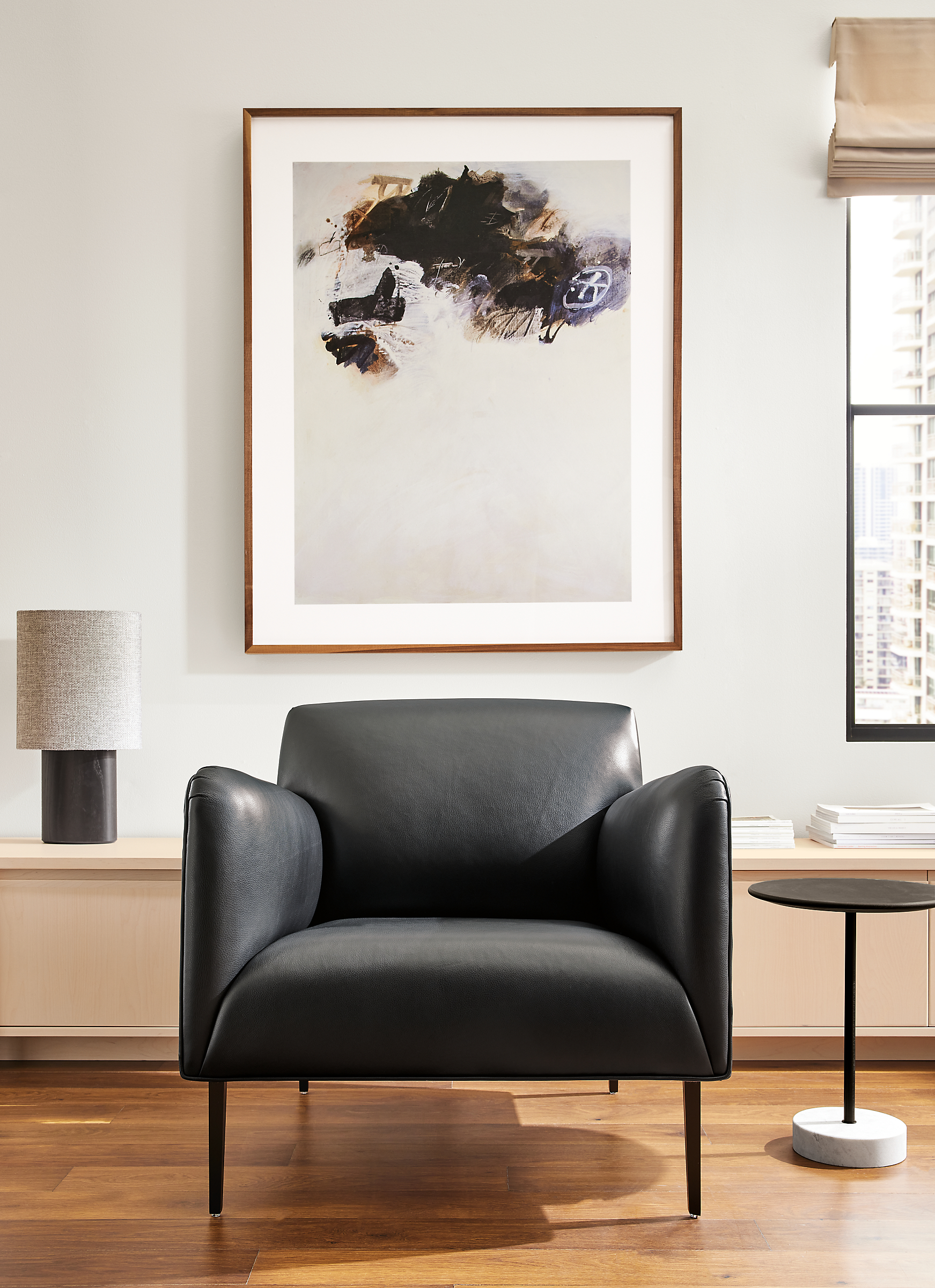 living room with matteo chair in urbino leather and gabriel belgeonne wall art.