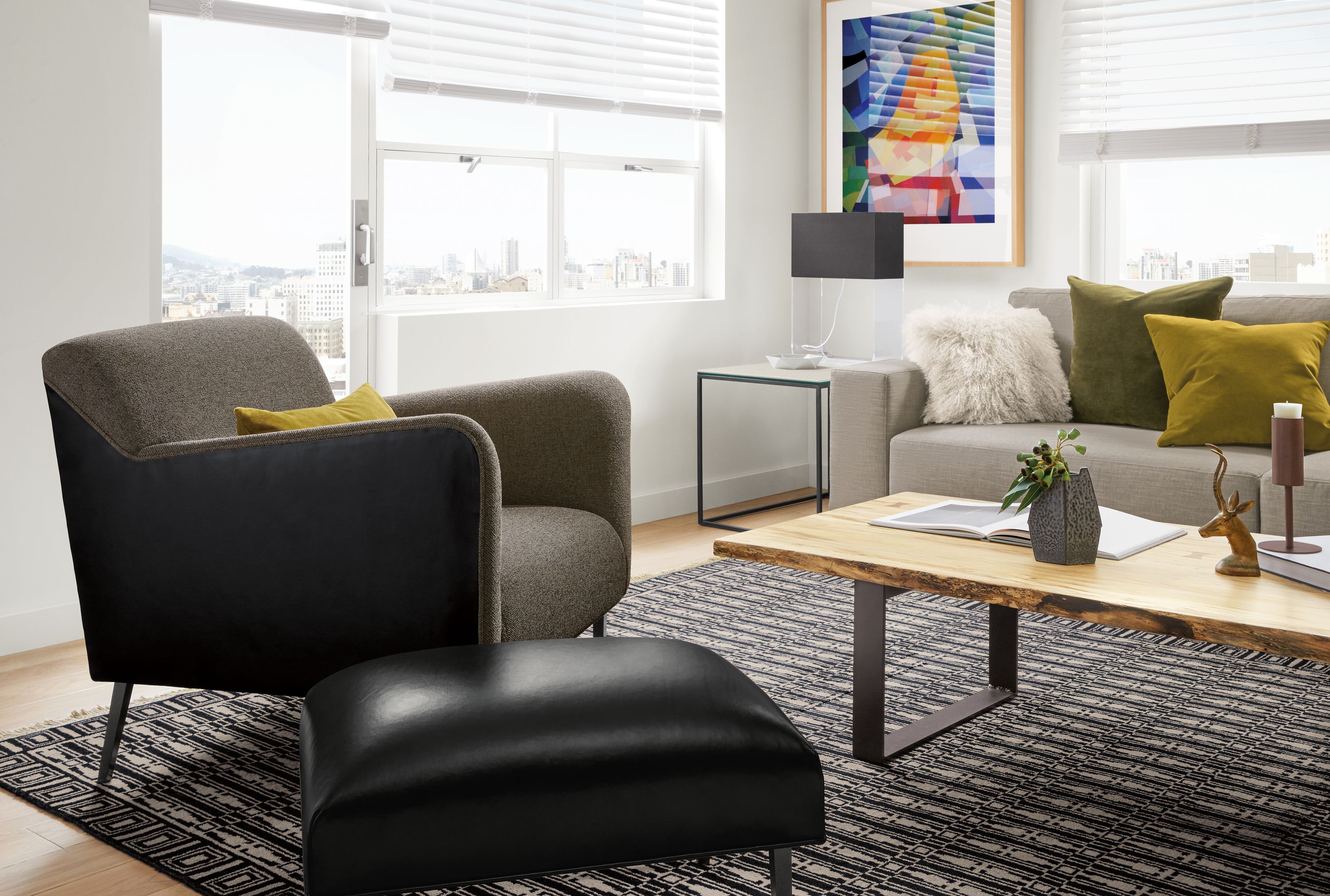 Detail of Matteo fabric & leather chair in Tatum Graphite fabric and Vento Black leather in living room.