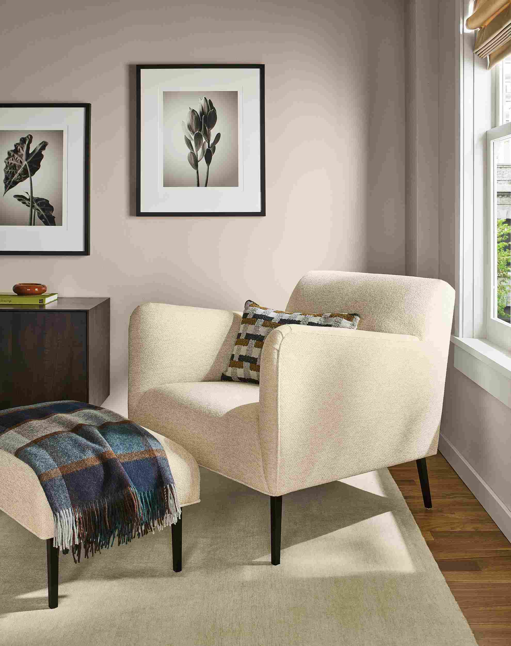 Room with detail of matteo chair and ottoman in tatum natural, hudson cabinet in charcoal and luco rug in silver.