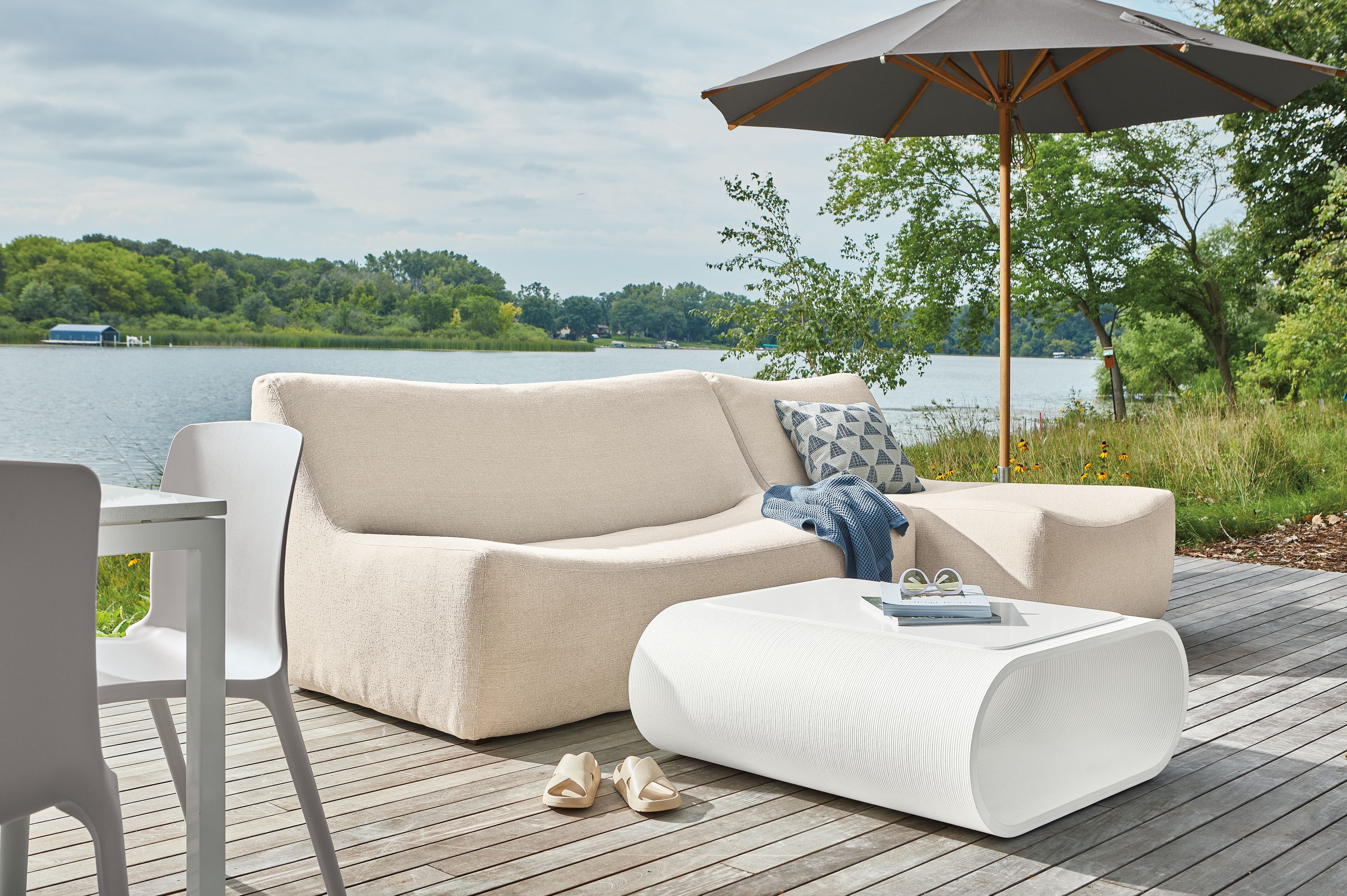 Maya 106-inch two piece outdoor sofa and chaise in Nevan Oatmeal fabric with Tangent 36-square outdoor coffee table in white.