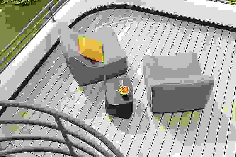 Overhead view of balcony with 2 Maya Armless Chair in Sunbrella Canvas Charcoal and a Gehry left twist Cube in black.