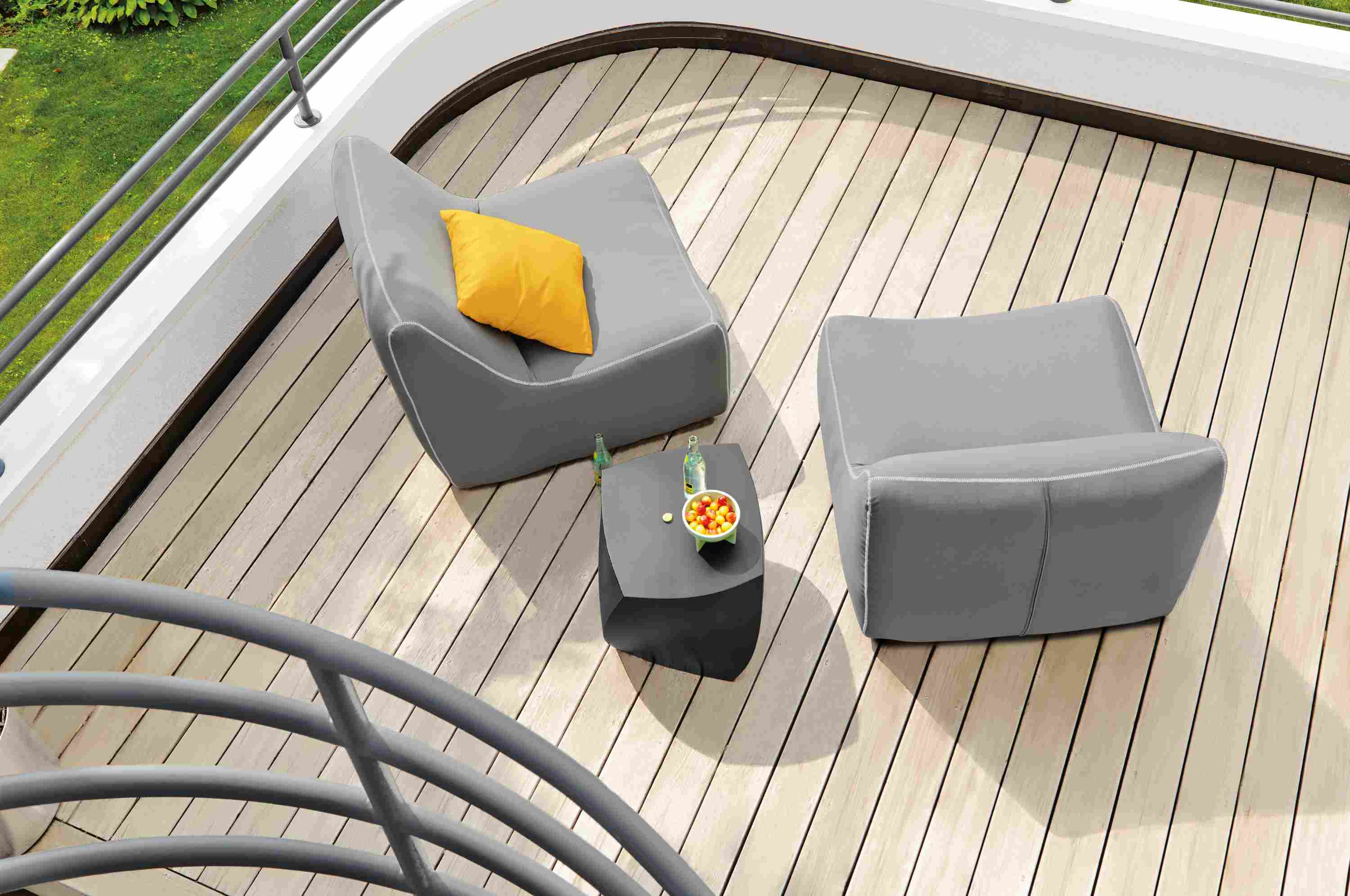 Overhead view of balcony with 2 Maya Armless Chair in Sunbrella Canvas Charcoal and a Gehry left twist Cube in black.