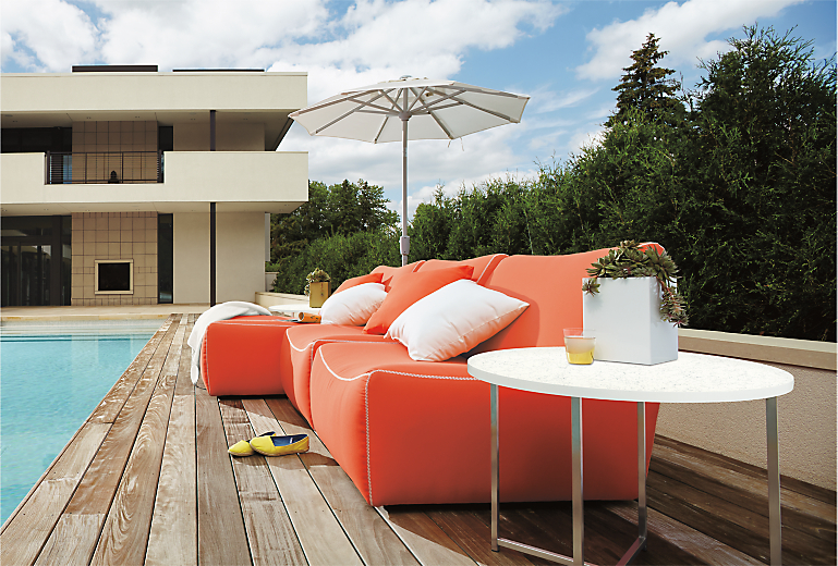 Outdoors with Maya armless chair in sunbrella canvas orange.