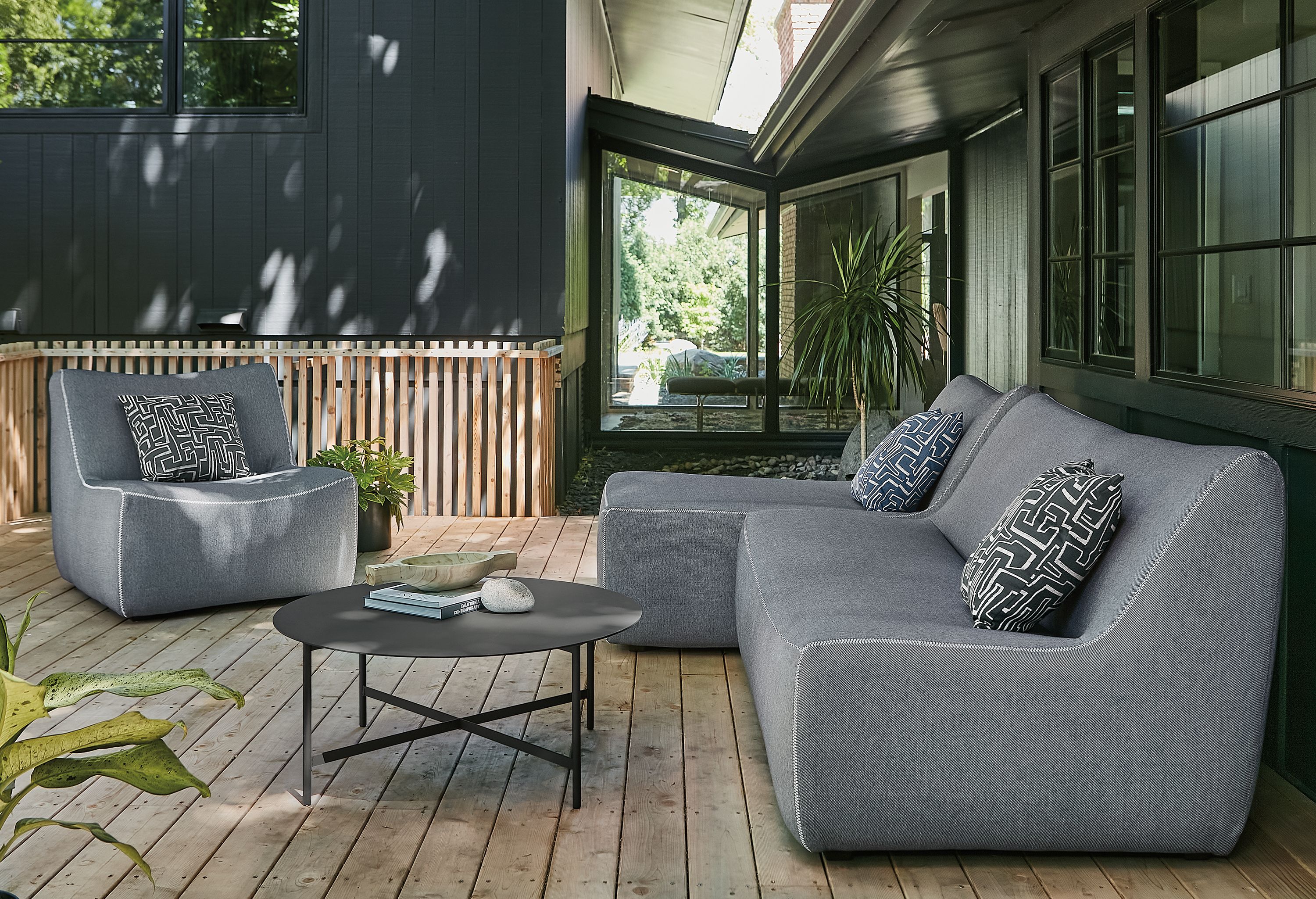 Outdoor space with maya two-piece modular sofa and maya chair.