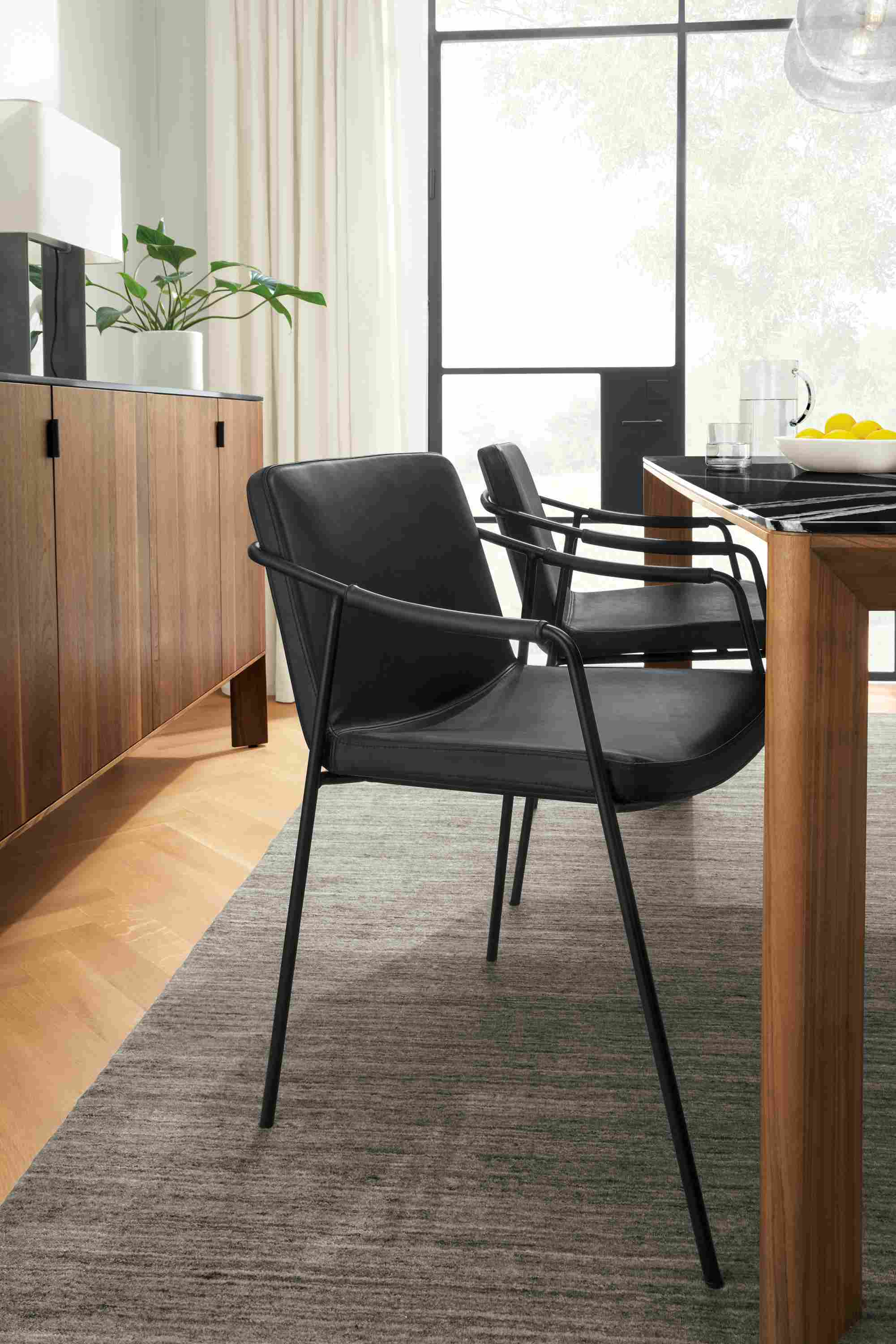 Detail of Mazie synthetic leather chair in Graphite at Pren table.