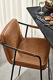 Detail of Mazie synthetic leather counter stool in Brown set at counter.