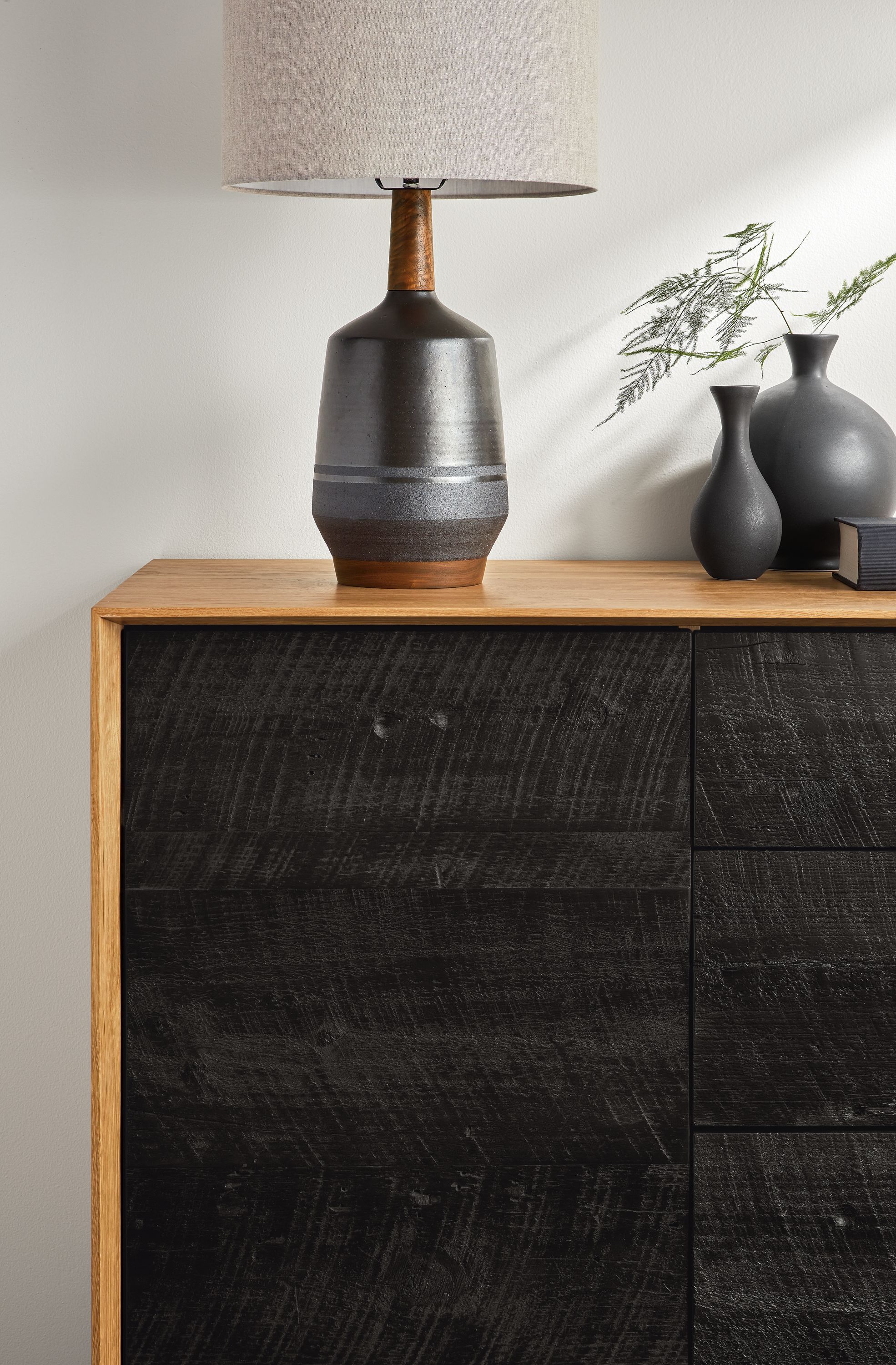 Close-up of a Meriden Table Lamp on a McKean 72-wide Reclaimed Wood Media Cabinet in Walnut case and Charcoal doors.